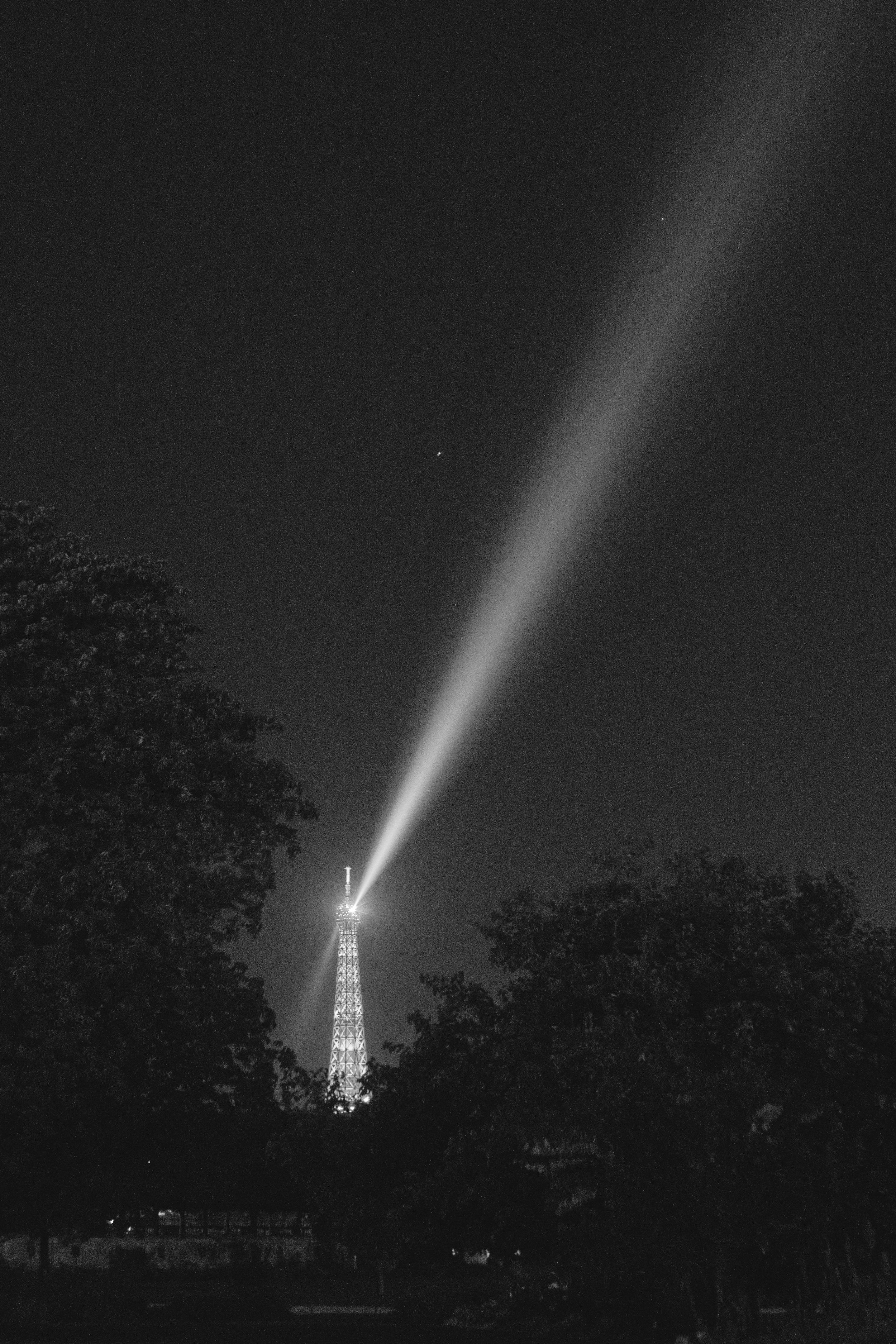 Paris has been photographed millions of times, yet black and white has a way of making it feel timeless again. As the Eiffel Tower swept its light across the night sky, the grain and contrast gave the scene the quiet character of an old film frame.