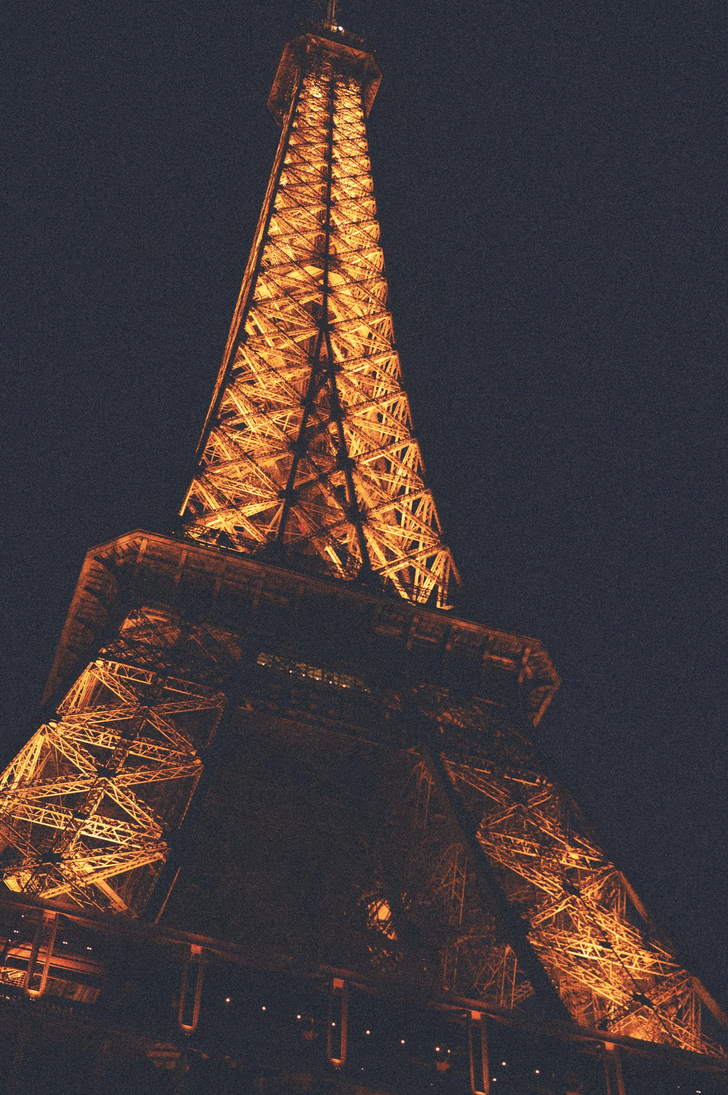 There is something about analog film that digital perfection can never fully replace. The grain, the imperfections, and the warm glow breathe soul into a photograph, making it feel remembered rather than merely captured. Standing beneath the Eiffel T