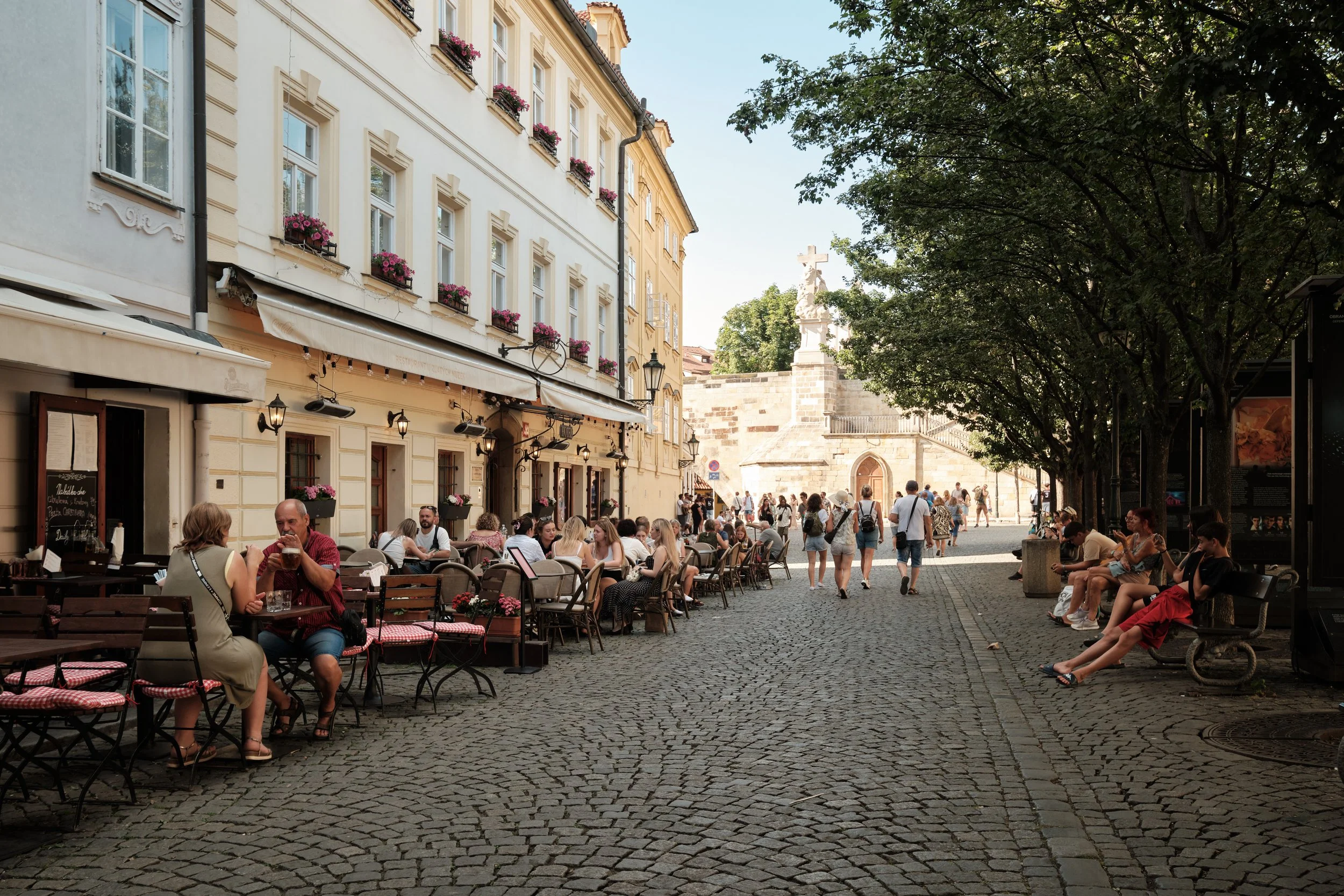 A Pause Between Landmarks -

Some of Prague’s most memorable moments aren’t found at its famous viewpoints, but along its quieter streets. Here, café terraces, cobblestones, and afternoon light invite visitors to slow down and simply enjoy the city.