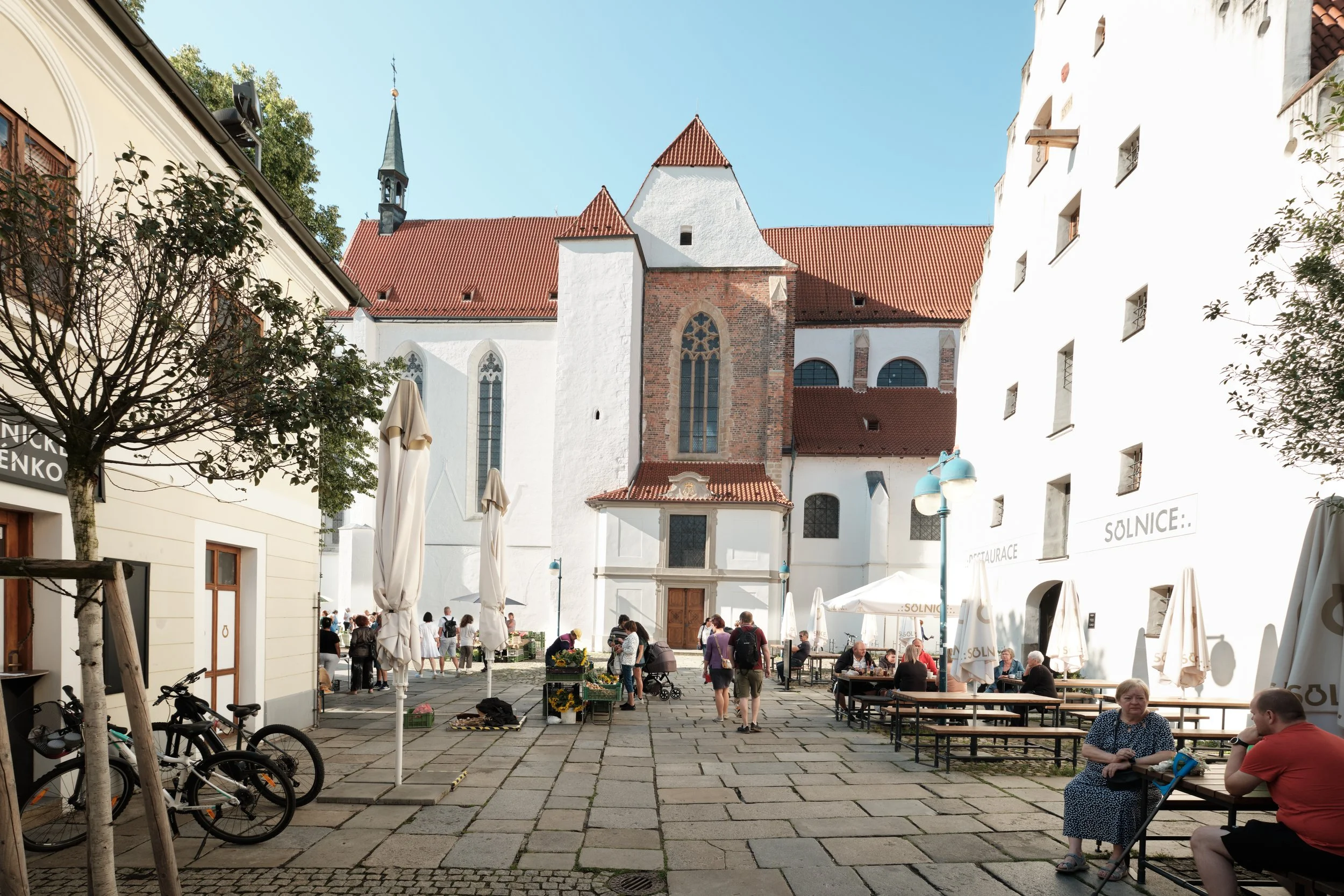 Tucked behind the busy streets, the Dominican Monastery opens into a peaceful courtyard where Gothic architecture, quiet conversations, and afternoon light create one of České Budějovice’s most inviting historic spaces.