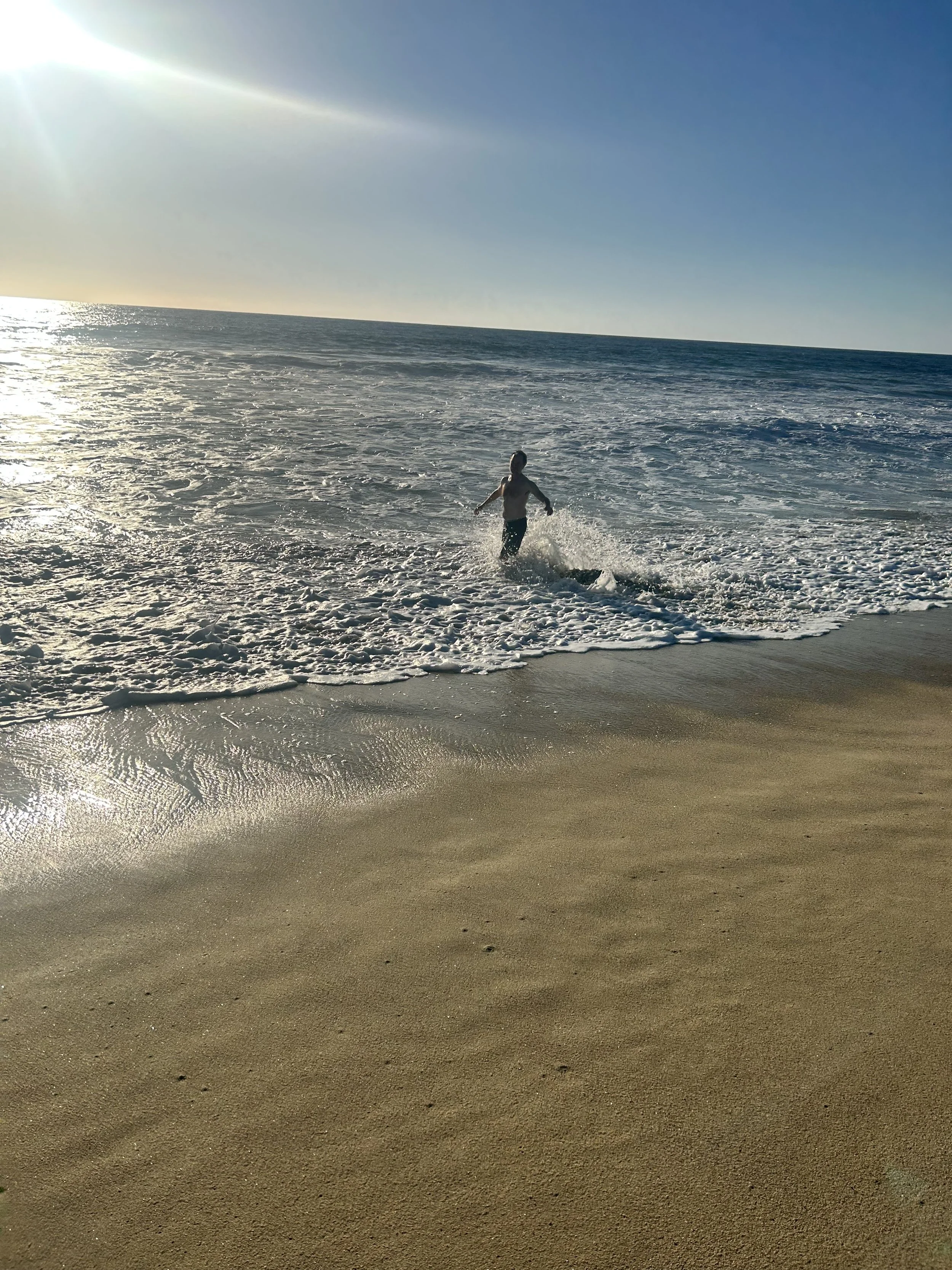 PR 2026 john playing in the ocean.jpeg