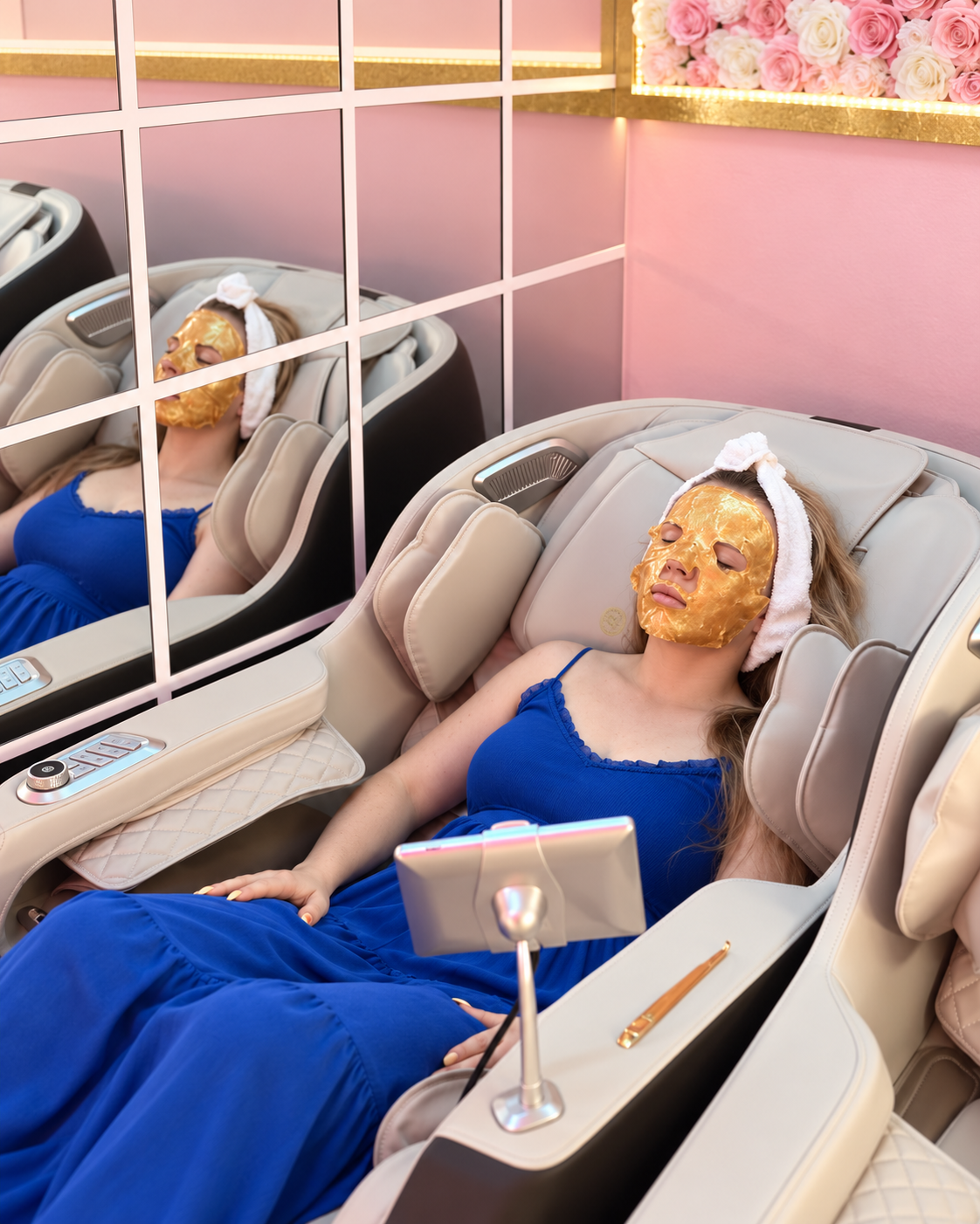 A client relaxing with Zero Gravity Massage Chairs while the golden collagen mask is absorbed in her skin.