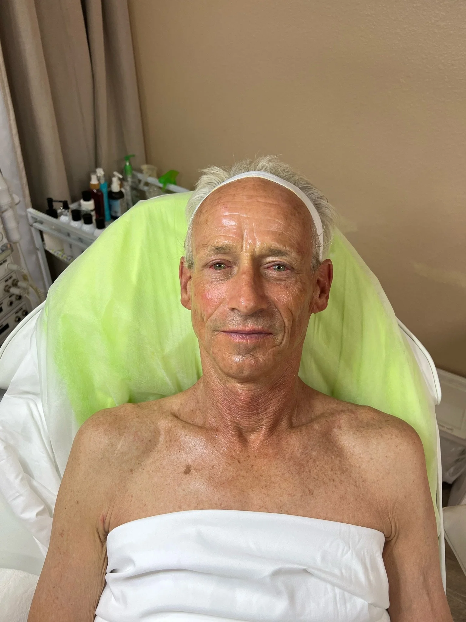 A man smiling from his men's facial at Kiwi Spa San Diego.