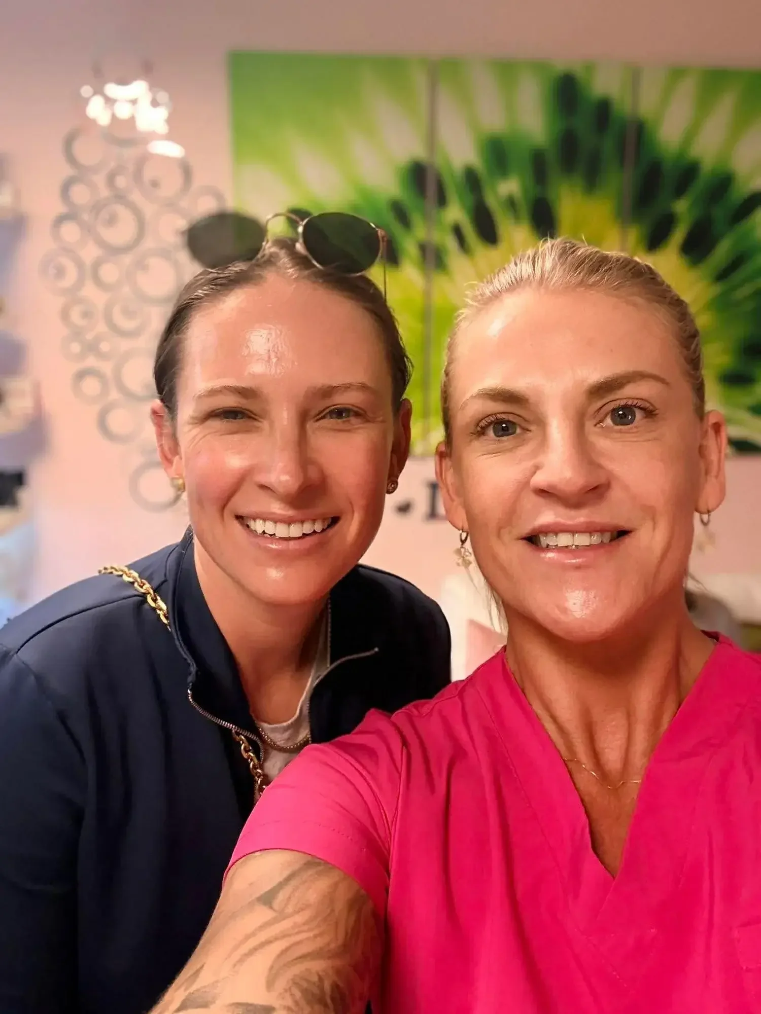 An esthetician and a client smiling side by side at Kiwi Spa