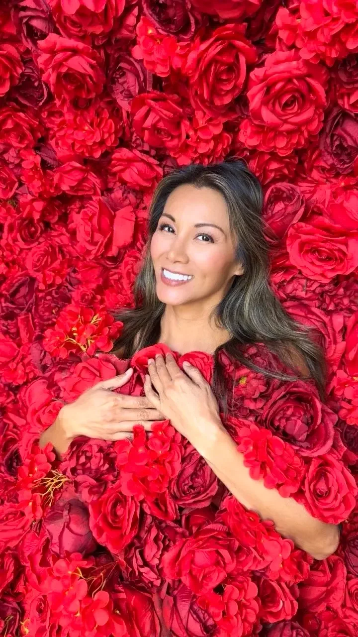 A woman laying on the Red Roses at Kiwi Spa's Red Rose Photozone