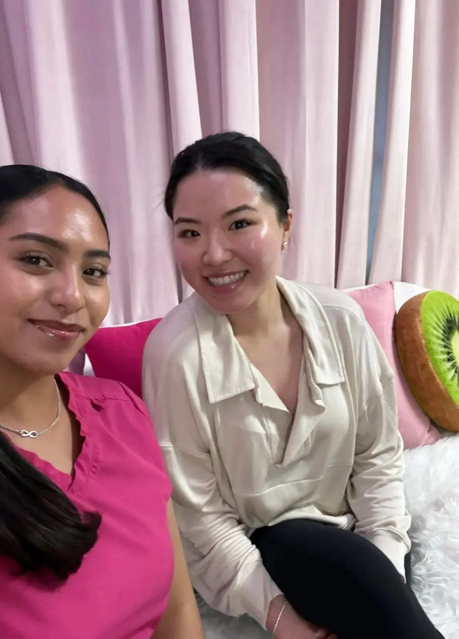 An acne facial client with glowing skin, smiling beside her esthetician at Kiwi Spa