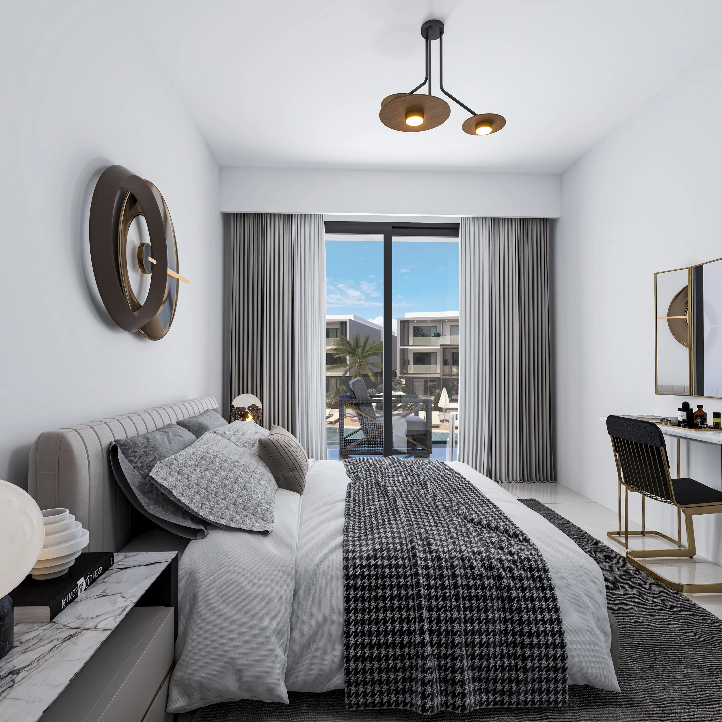 Modern bedroom with a large bed, decorative pillows, checkered blanket, nightstand with books and decor, sliding glass door leading to a balcony with outdoor seating, palm tree, and neighboring buildings, contemporary ceiling light, floor-length curtains, and a vanity with a mirror.