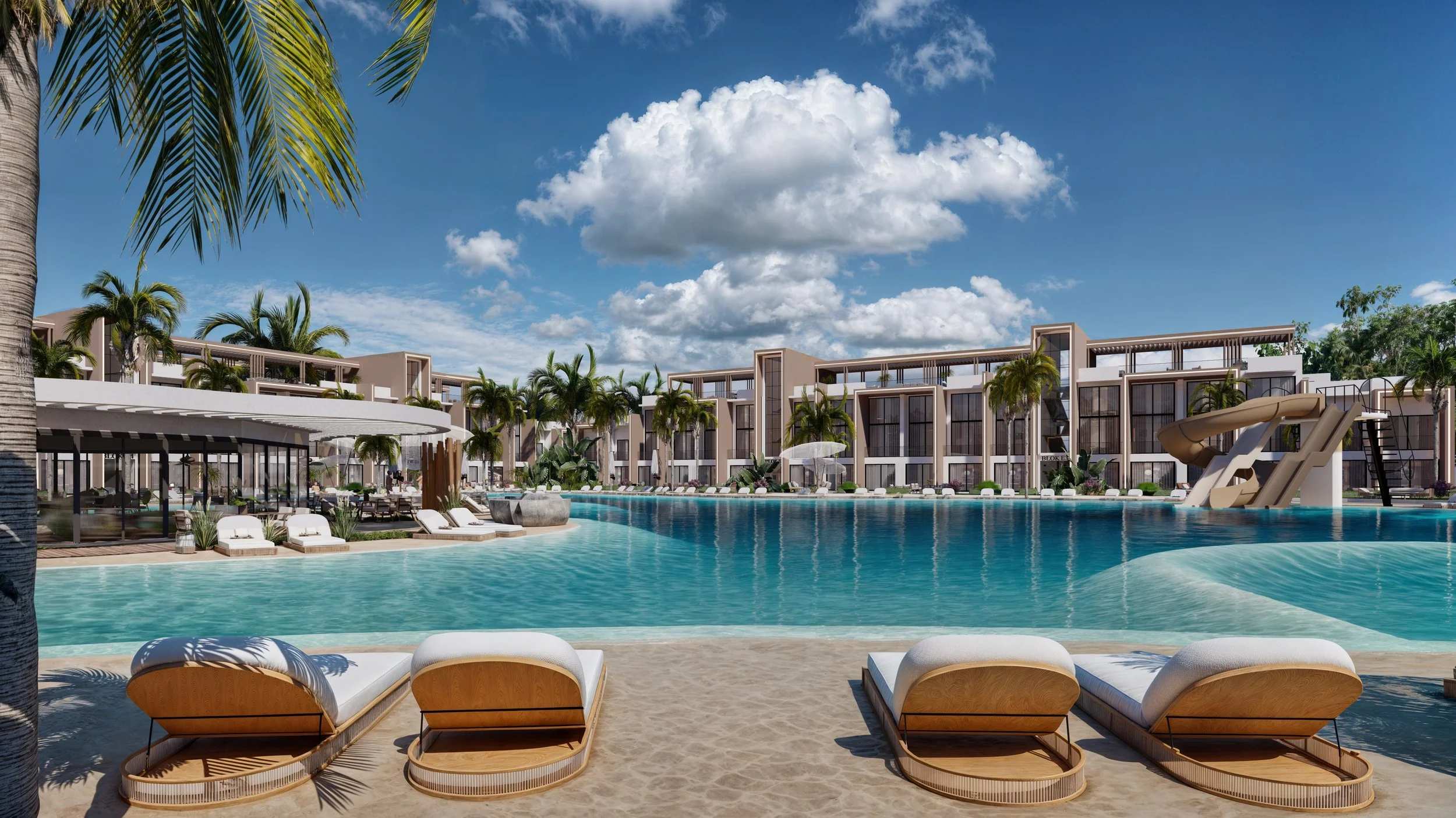 Luxury resort pool area with lounge chairs, palm trees, a waterslide, and modern buildings in the background under a partly cloudy sky.