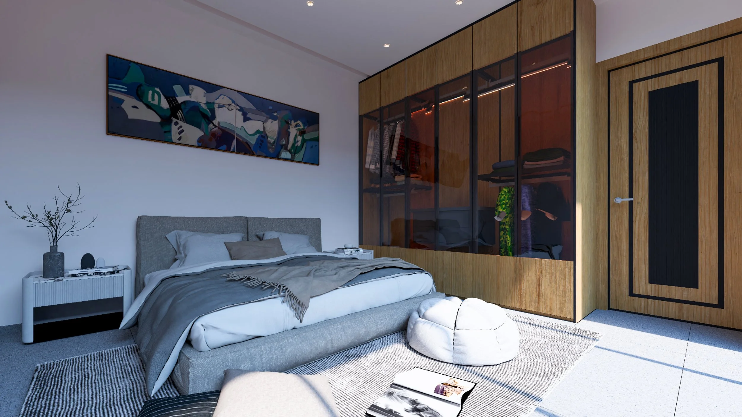 Modern bedroom with a gray upholstered bed, abstract artwork above, white nightstand with decorative items, open wardrobe with hanging clothes, and a white bean bag on a textured rug.