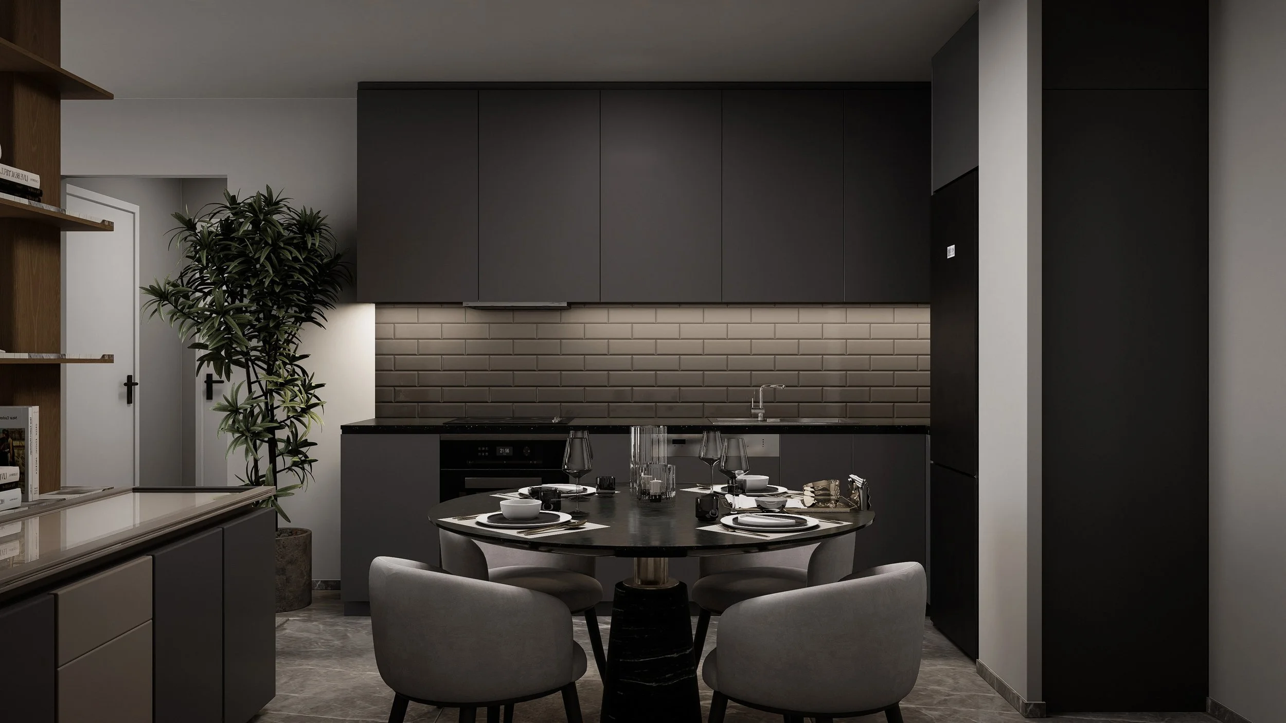 Modern kitchen with black cabinets, gray walls, a round dining table set with four place settings, a large potted plant on the left, and a gray brick backsplash.