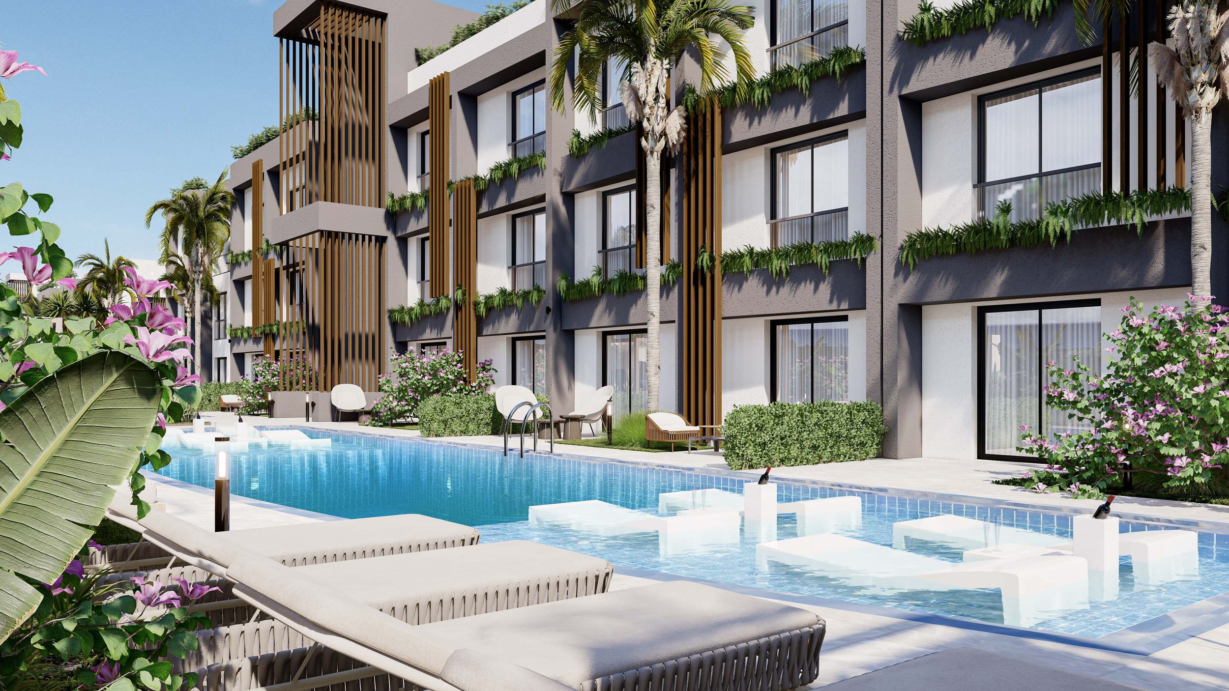 Modern apartment building with balconies decorated with greenery, overlooking a swimming pool with lounge chairs, palm trees, and flowering plants.