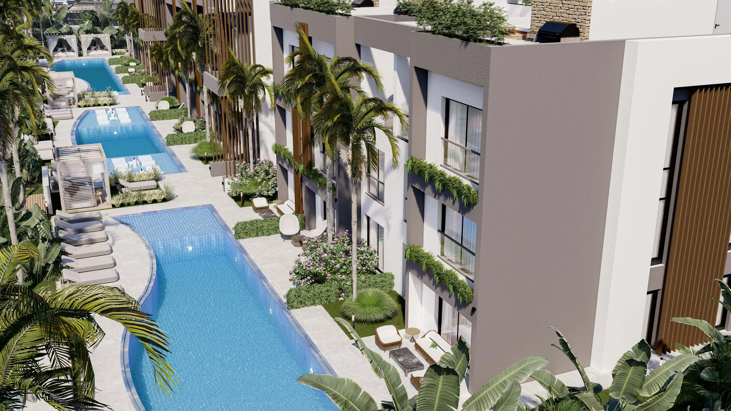 Aerial view of a modern apartment complex with balconies, lush greenery, tall palm trees, and a curving outdoor swimming pool with lounge chairs and shaded cabanas.