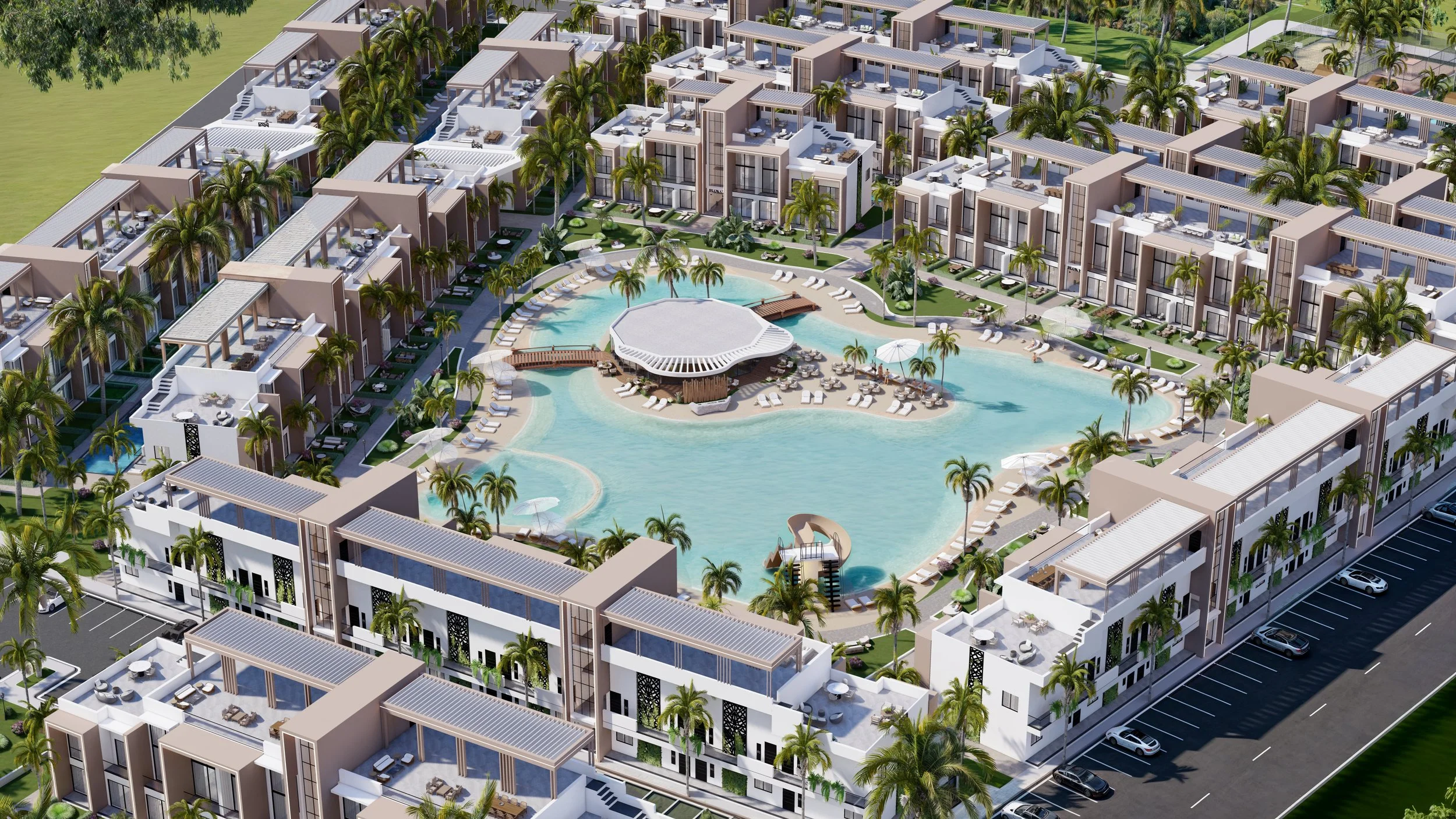 Aerial view of a modern residential complex with a large central swimming pool surrounded by palm trees, lounge chairs, and apartment buildings with terraces.