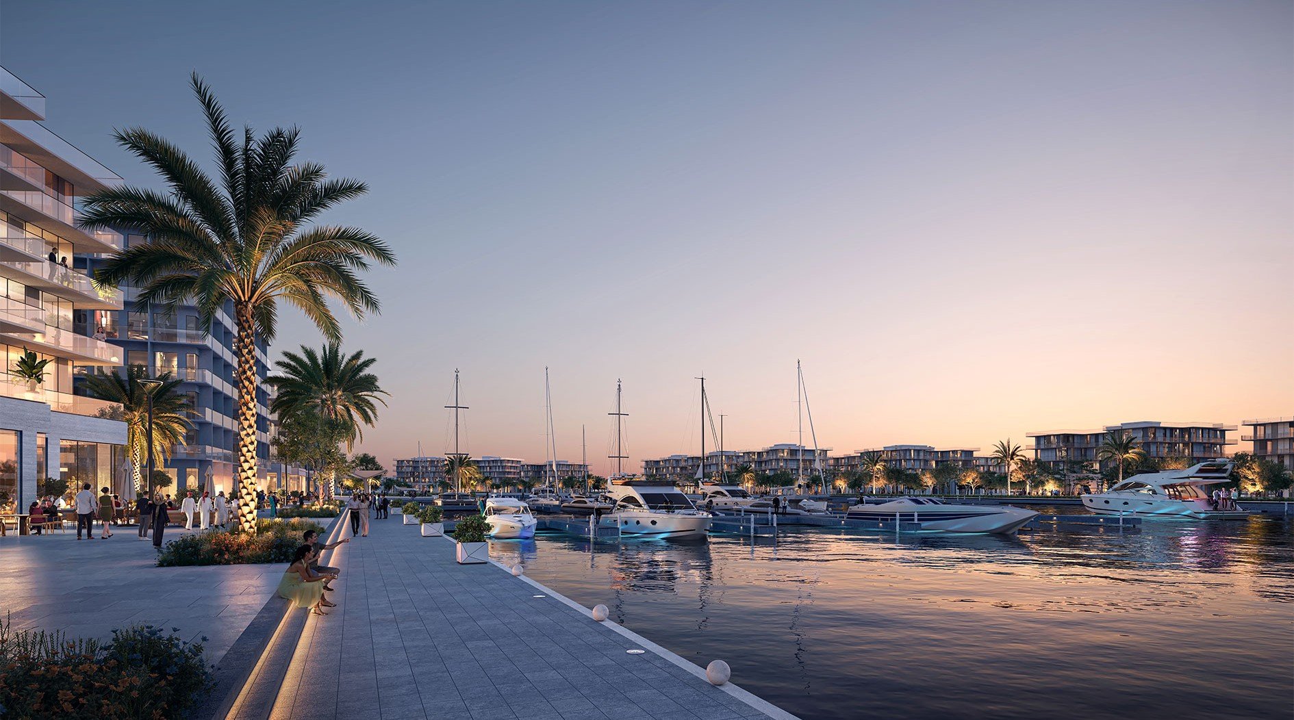 A marina with yachts docked along the waterfront at sunset, surrounded by modern residential buildings and palm trees, with people strolling and sitting along the promenade.