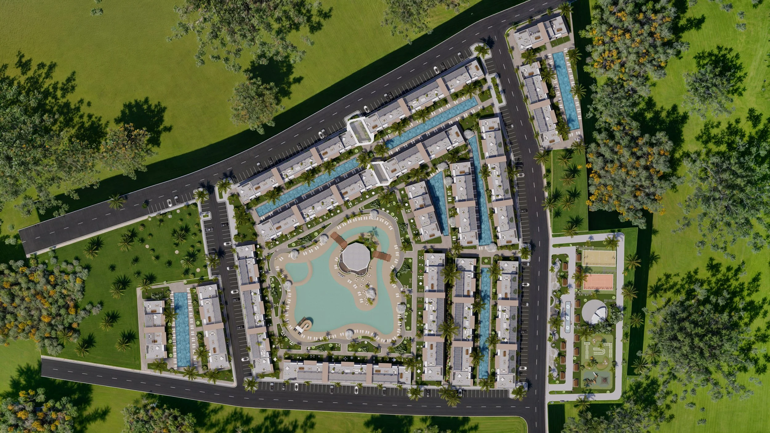 Aerial view of a large residential complex with multiple buildings, swimming pools, a central water feature, landscaped gardens, sports courts, and parking areas surrounded by green trees and lawns.