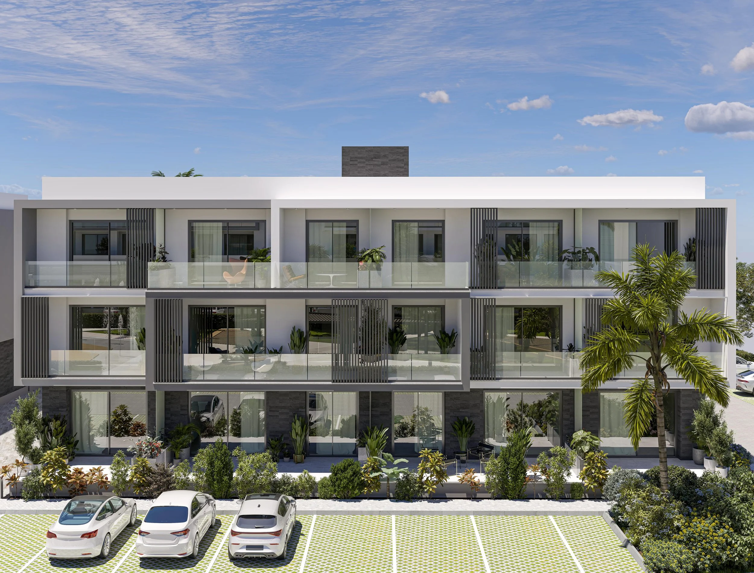 Three-story modern building with glass balconies, surrounded by plants, and parked cars in front, under a partly cloudy sky.