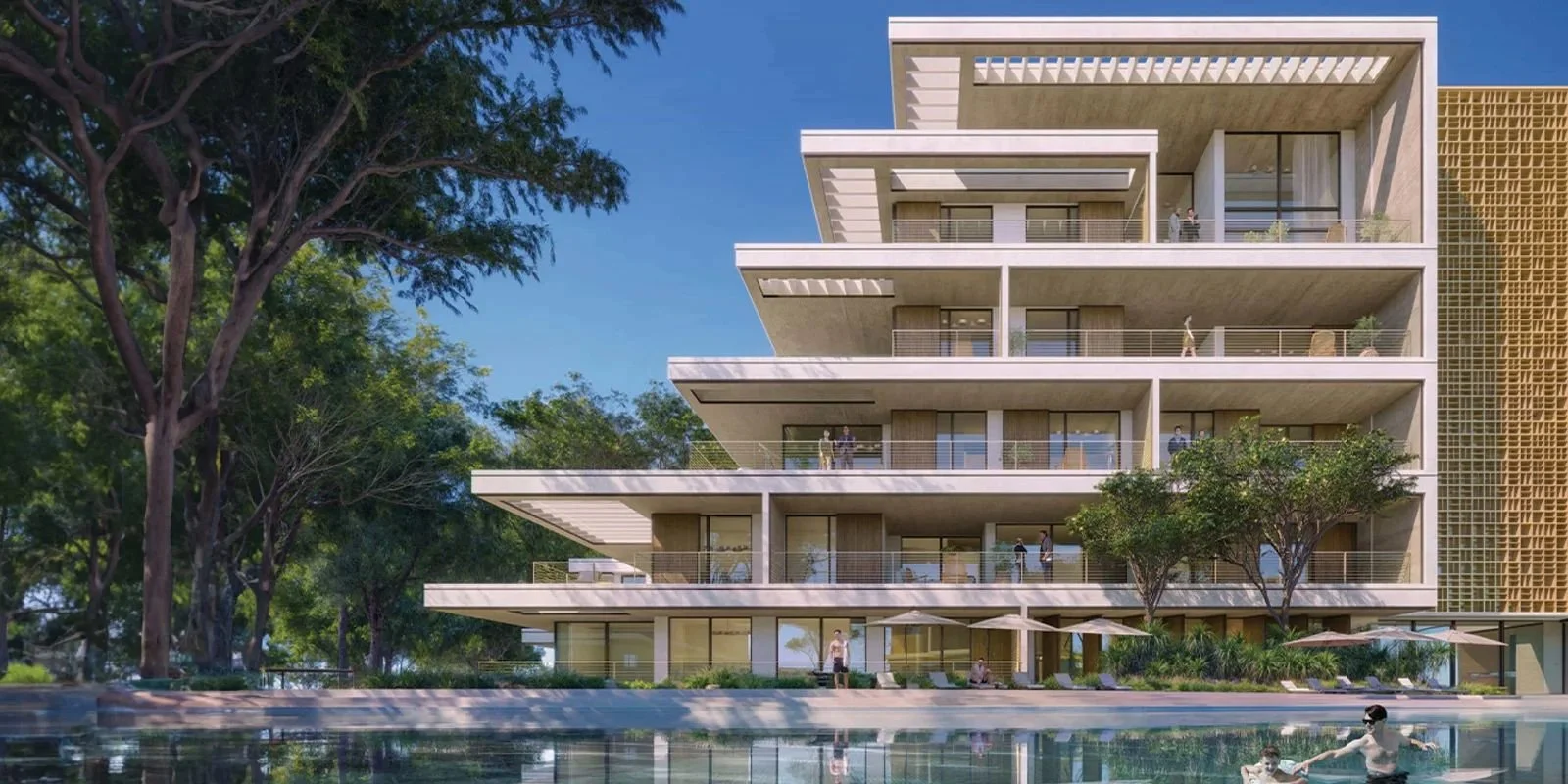 Modern multi-story apartment building with balconies, surrounded by trees, with a swimming pool in the foreground and people relaxing and walking around.