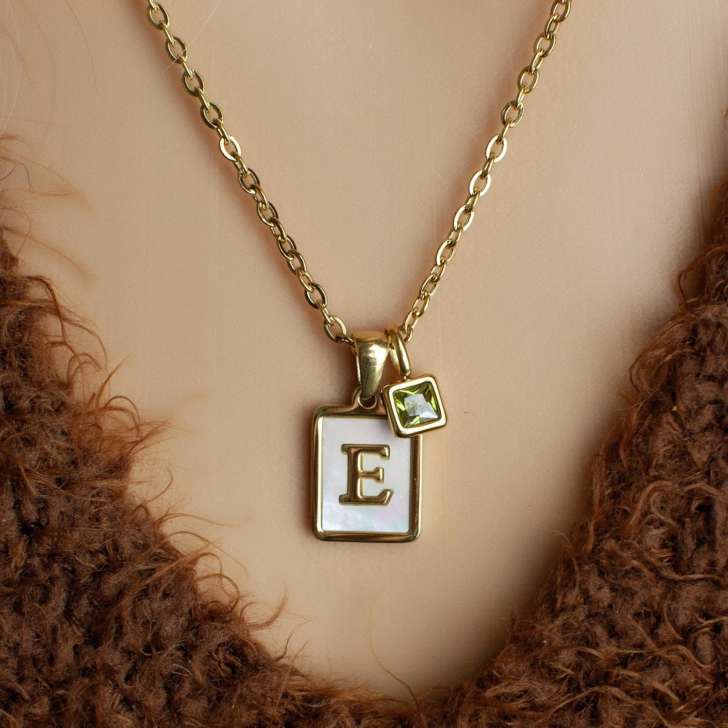 gold necklace with mother of pearl initial and birthstone charm