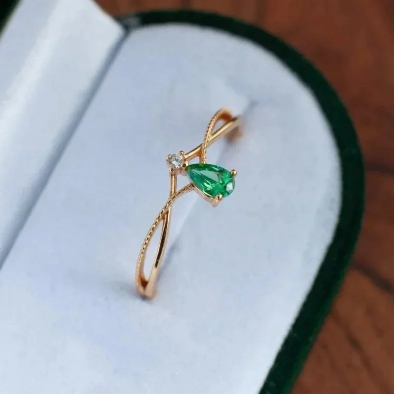 minimalist gold ring with a drop shape green stone