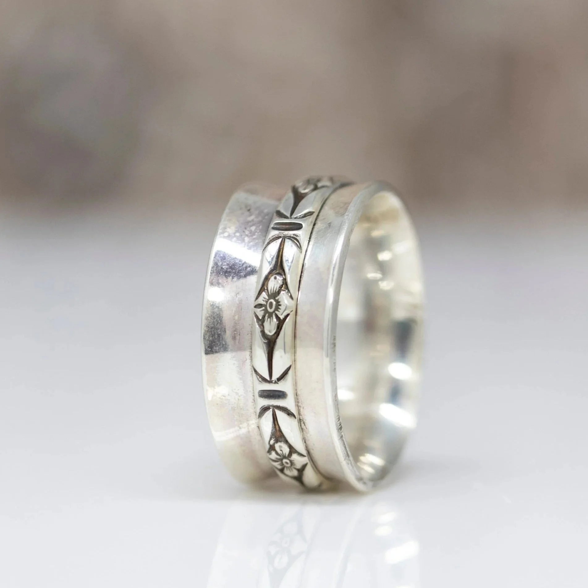 Floral spinner ring with a smooth rotating band, designed for calm, focus, and everyday comfort. A timeless fidget ring for stress relief and mindful wear.
