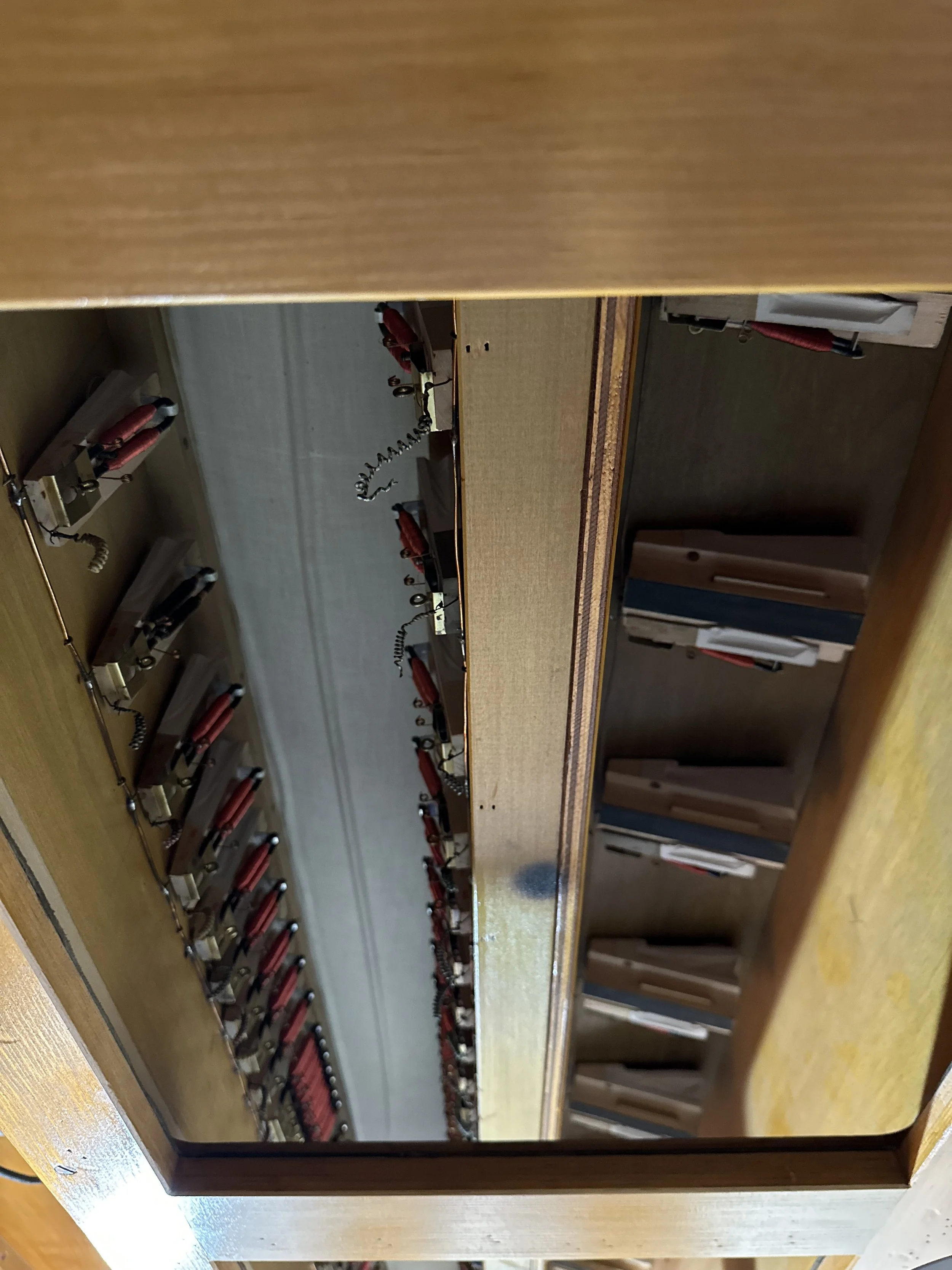 Here we have stripped out the old cotton-covered cables from inside the high-pressure Bombarde chest, leaving some wire to help us find the magnet piece.  This pigtail was removed when the new cabling was installed.