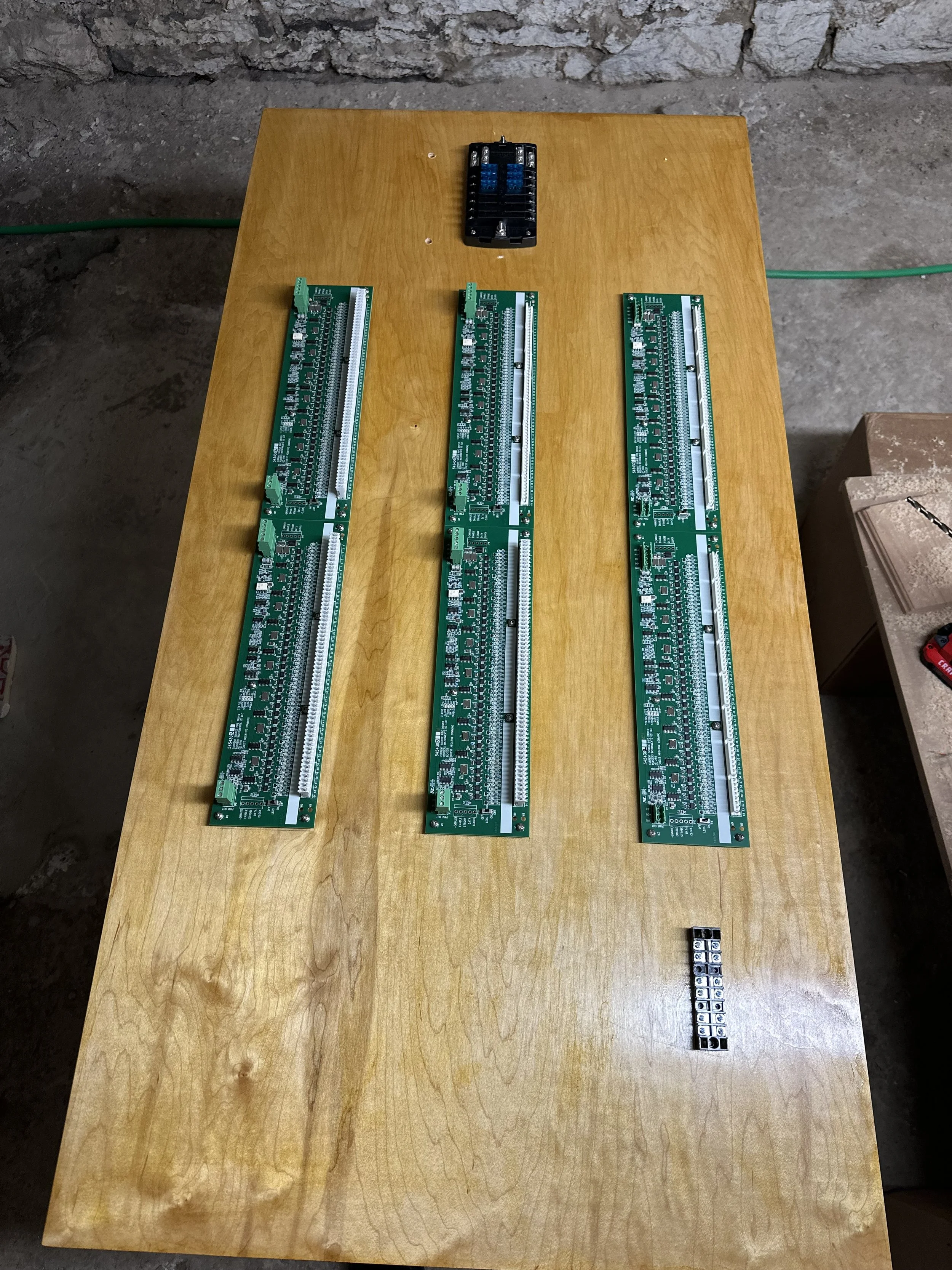 The Swell/Pedal driver panel, finished in orange shellac to match the Austin Universal Airbox.  This panel, now mounted inside the Universal Airbox, keeps the chest cables as short as possible.  A fuse block at the top keeps the wiring mains neat and