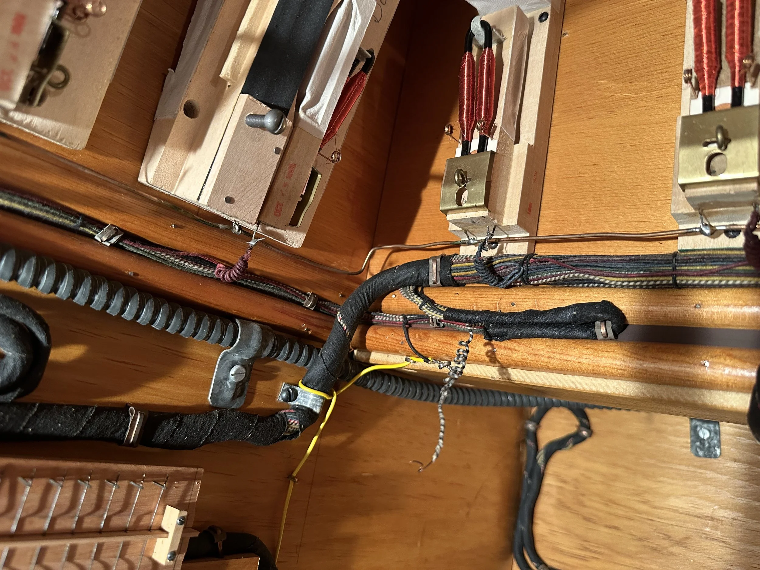 An example of the original Austin cotton-covered wiring, and a portion of an original electro-pneumatic/mechanical borrow switch.  All of this wiring was stripped out and replaced with new PVC color-coded wiring, and the mechanical switch was replace