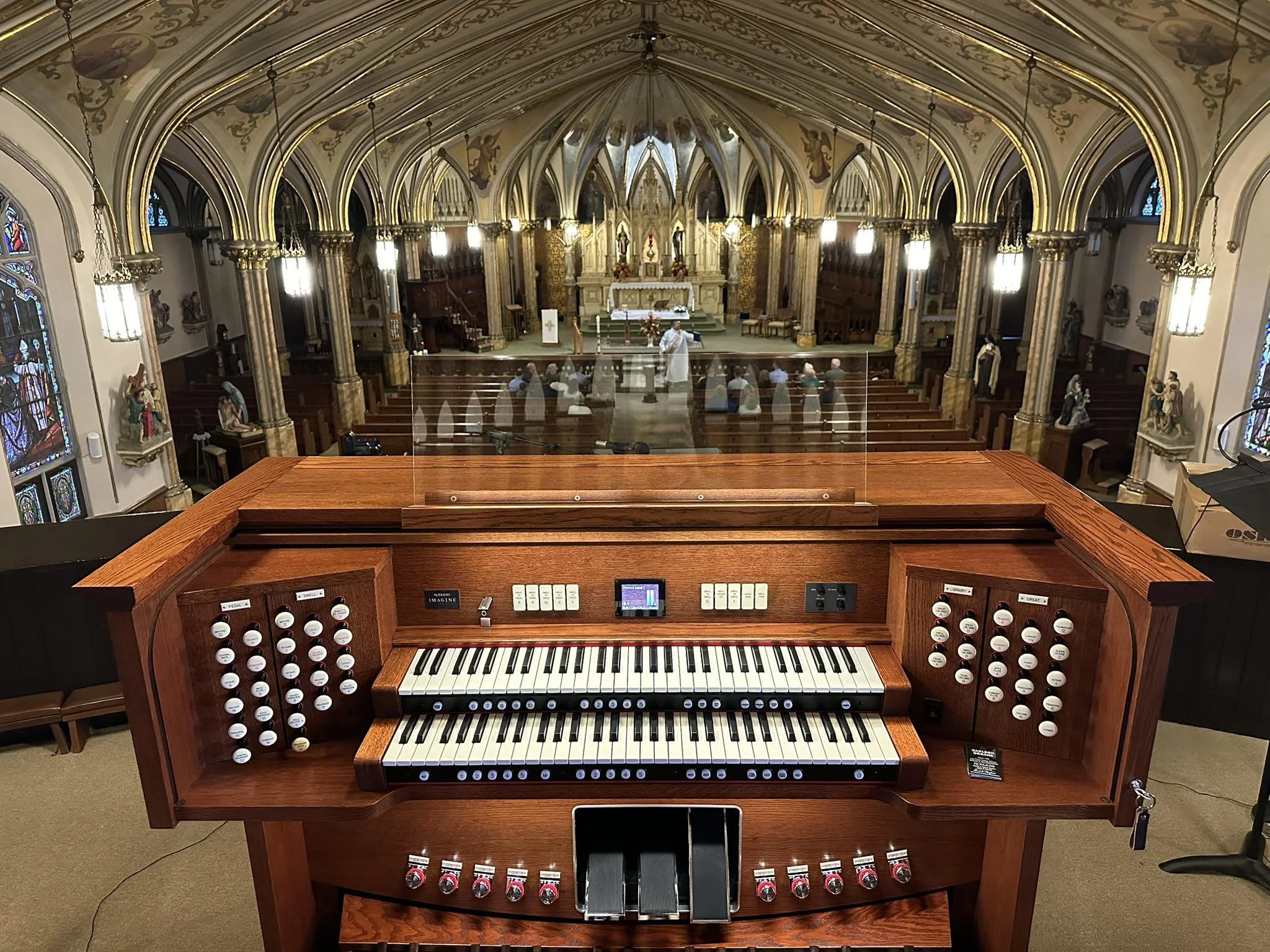 Rodgers organ in front of church sanctuary, overlooking balcony and congregation