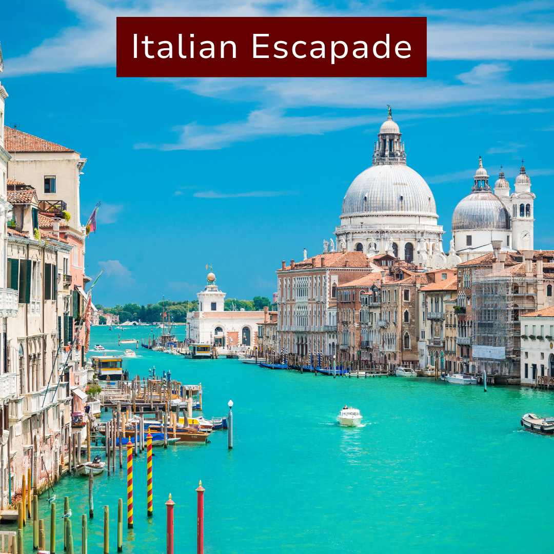 View of Venice canals with historic buildings and domed churches in the background, under a bright blue sky.
