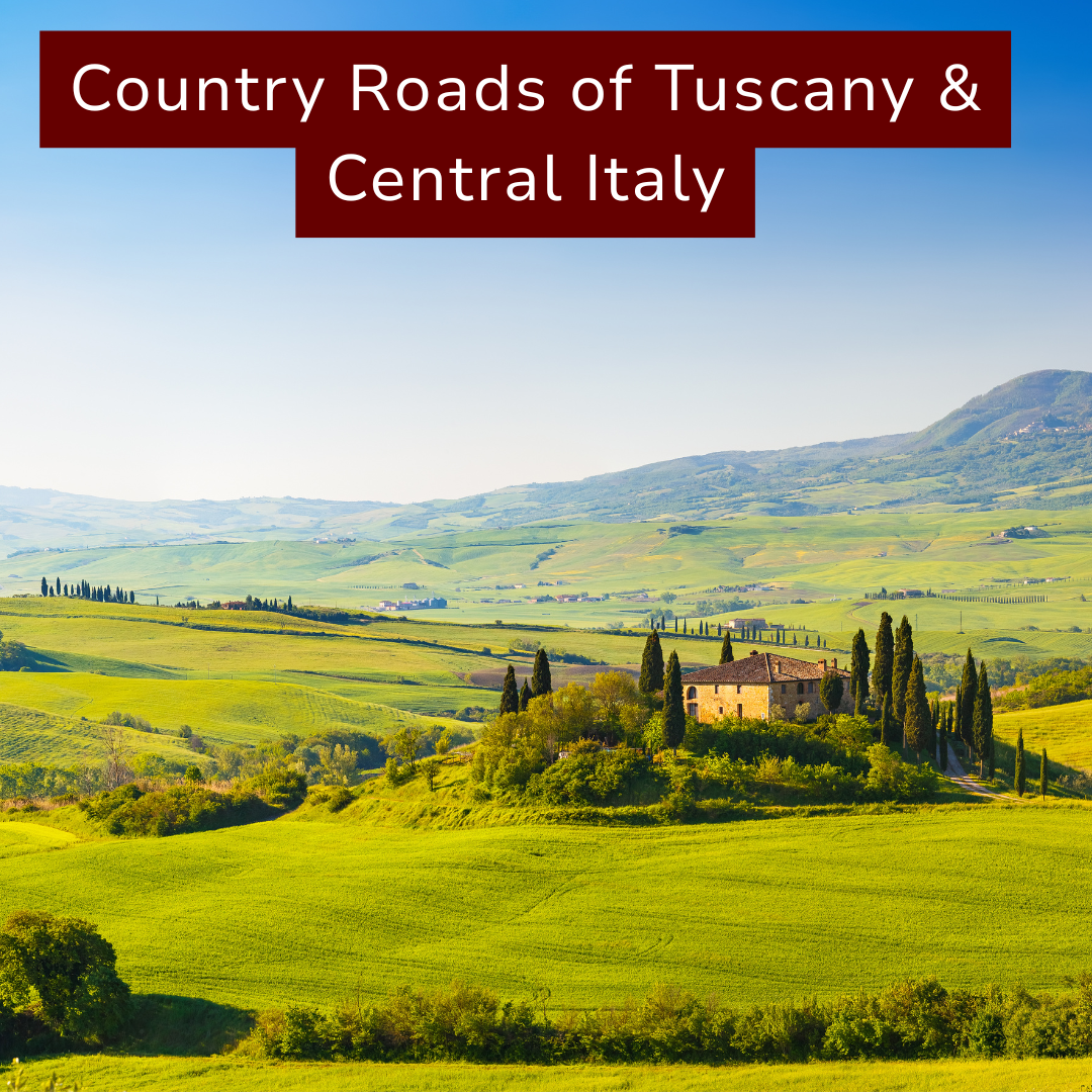Scenic landscape of rolling green hills and countryside in Tuscany, Italy, with a stone house surrounded by cypress trees under a blue sky.