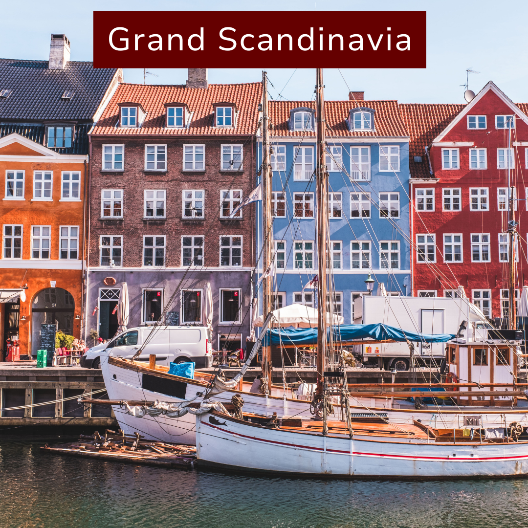 Colorful buildings along a harbor with boats docked, with the text "Grand Scandinavia" at the top.