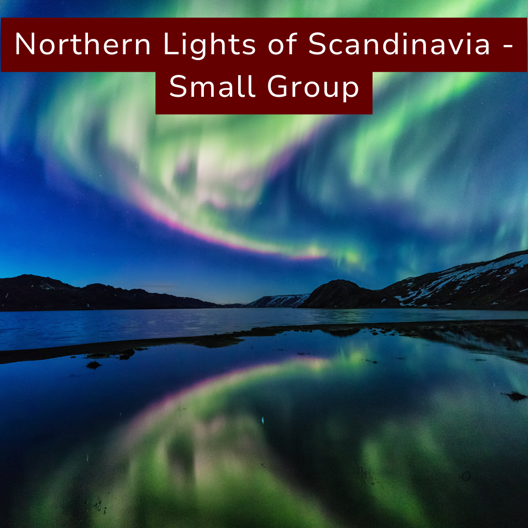 Northern Lights over a body of water with mountains in the background