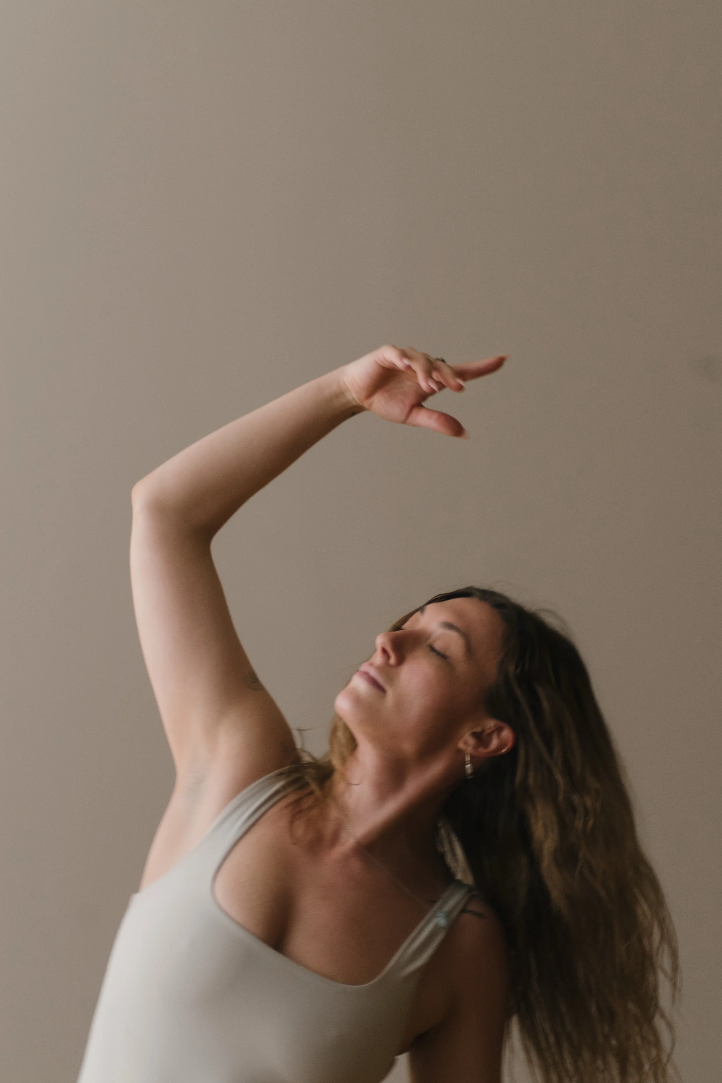 A woman with eyes closed, in a yoga flow at Soma Movement in Bedford NS
