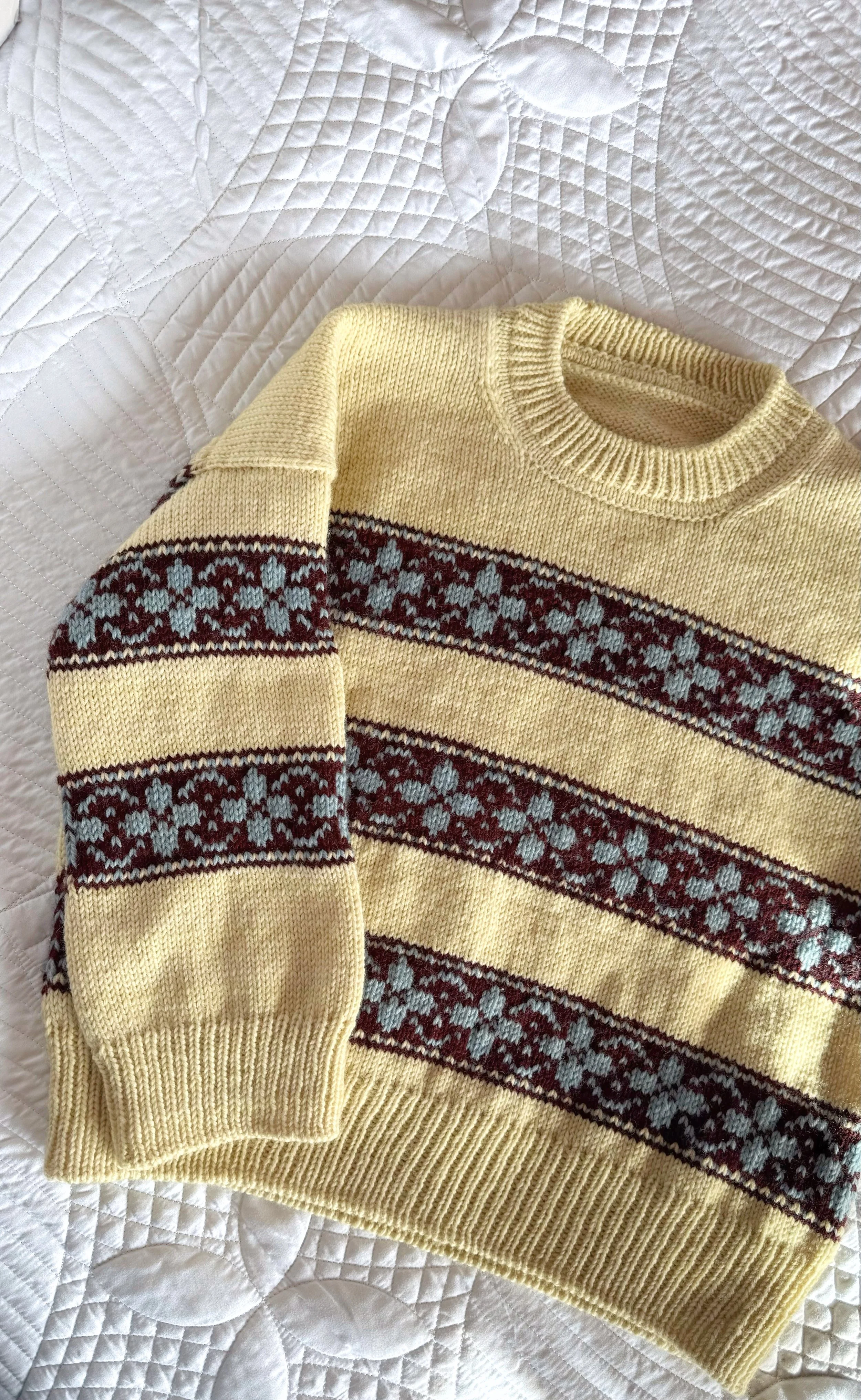 hilda sweater in yellow base with colorwork stripes in burgundy, and flowers in light blue