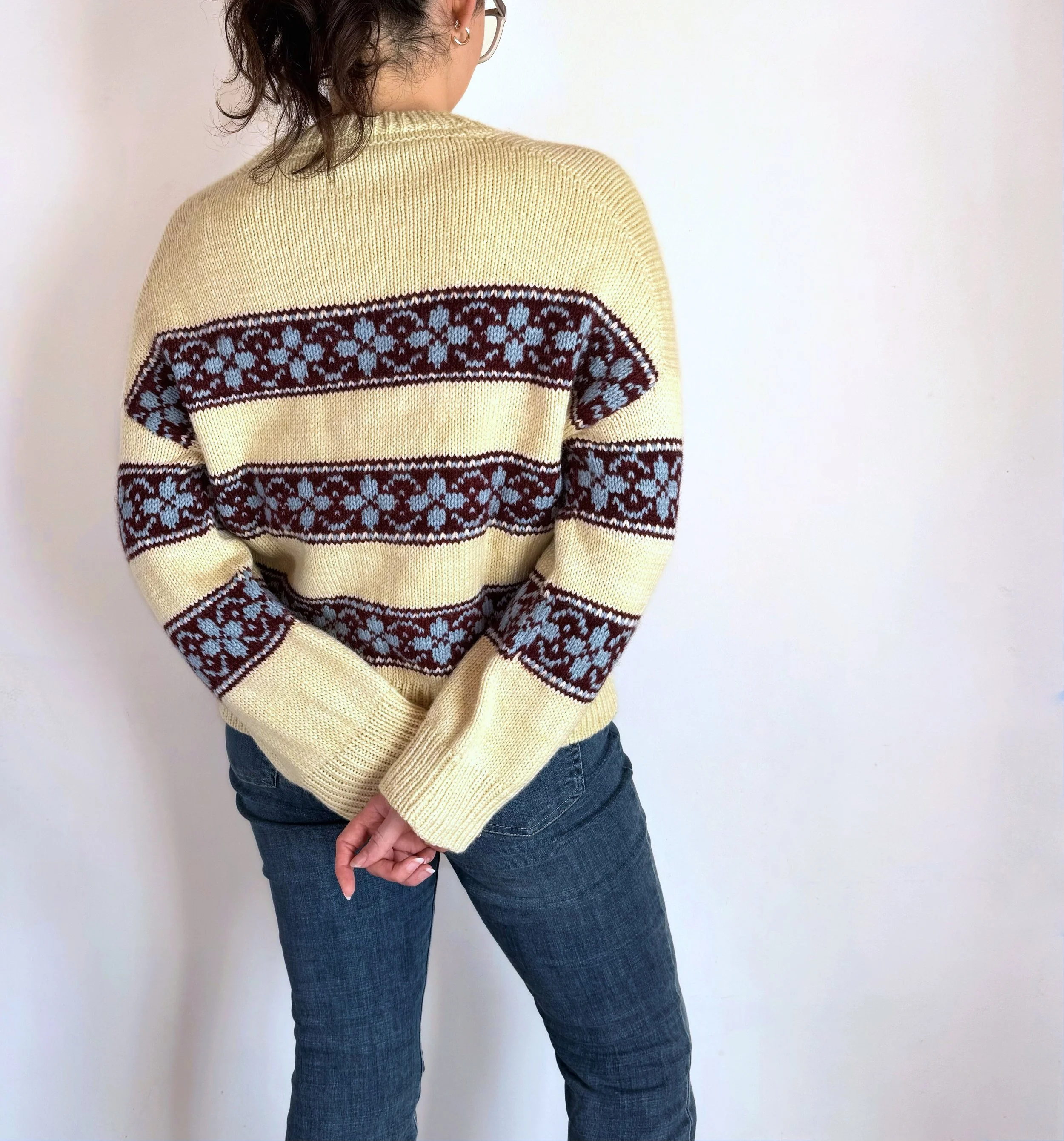 hilda sweater in yellow base with colorwork stripes in burgundy, and flowers in light blue