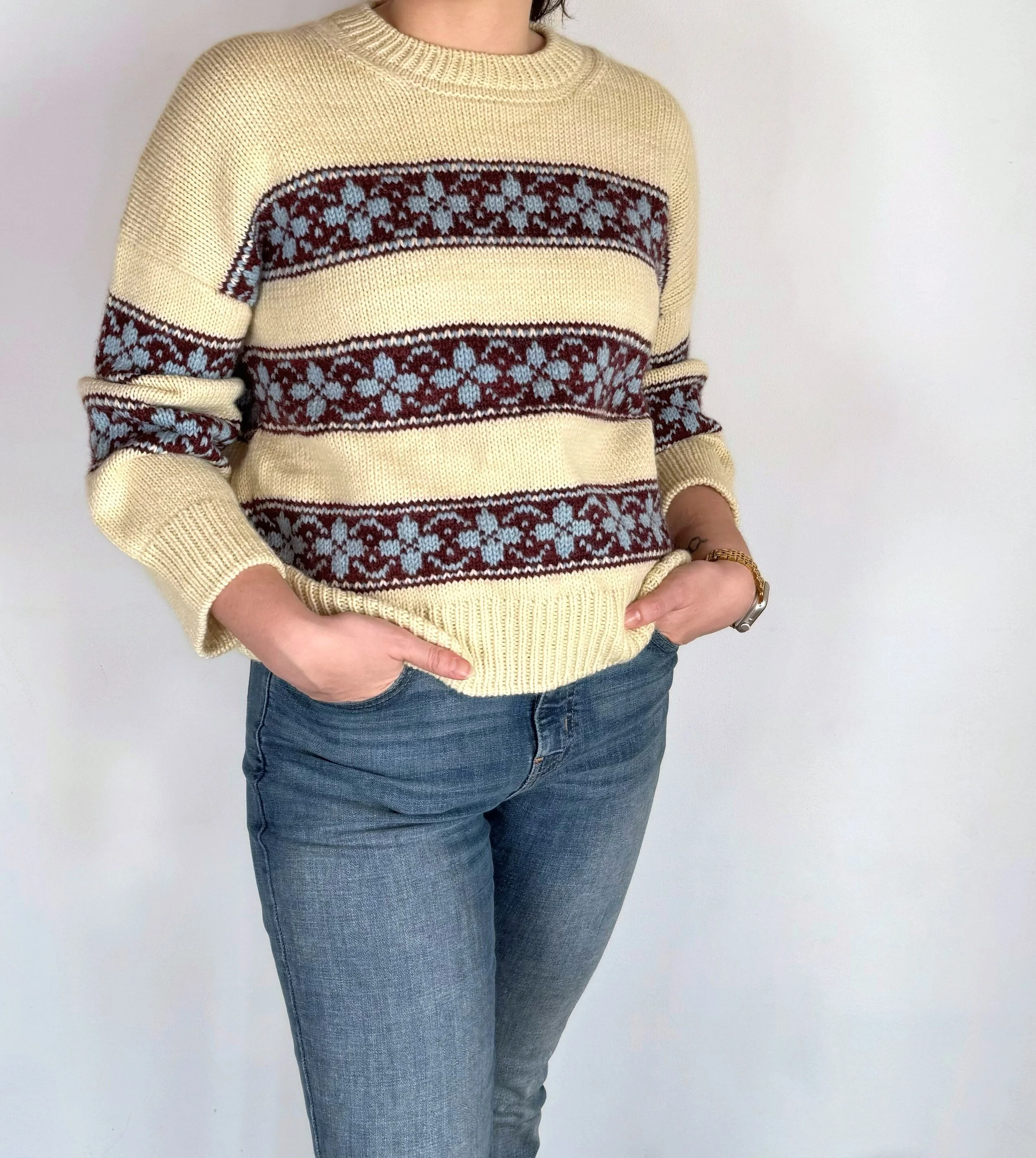 hilda sweater in yellow base with colorwork stripes in burgundy, and flowers in light blue