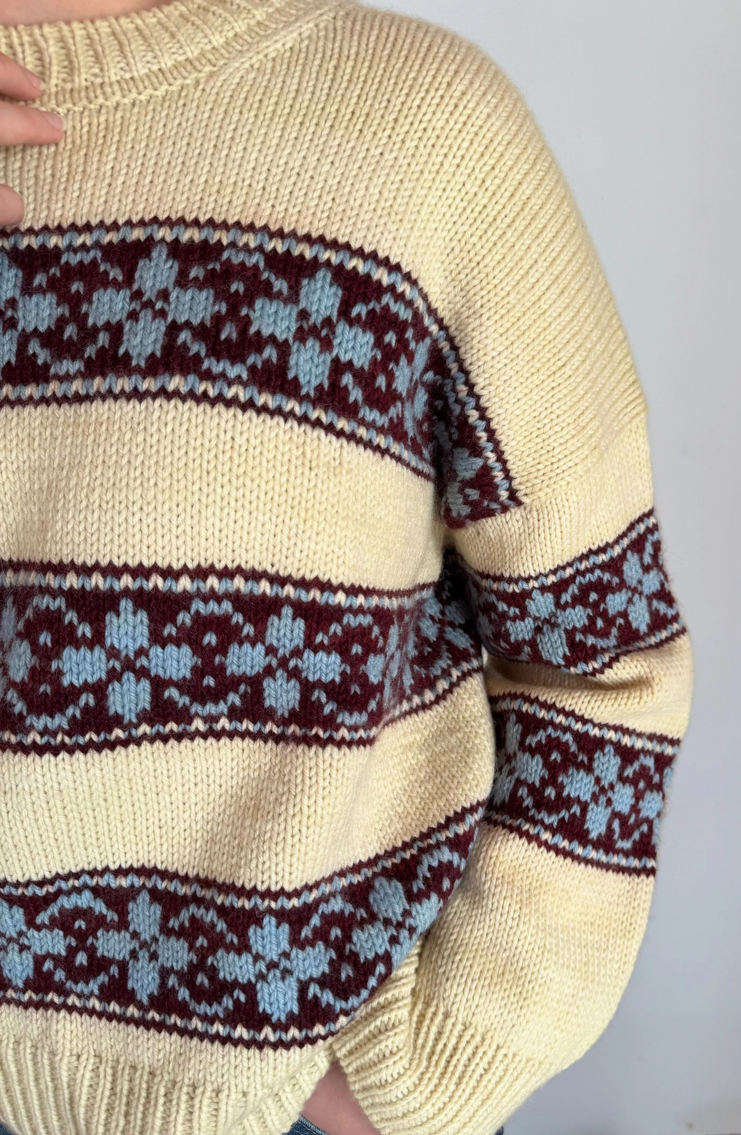 hilda sweater in yellow base with colorwork stripes in burgundy, and flowers in light blue