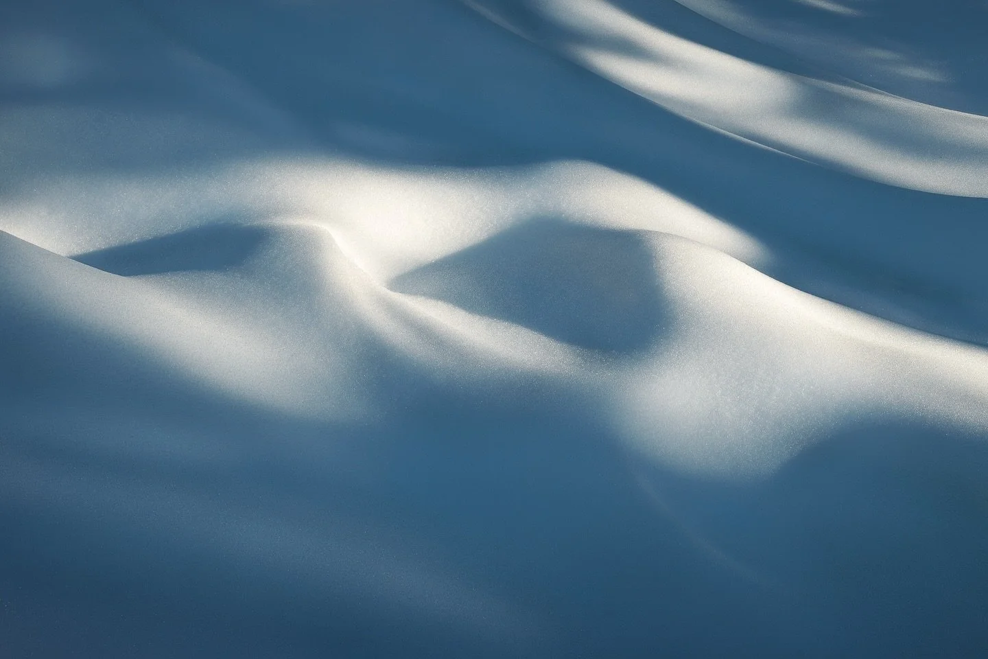 Decided to slow down and shoot something more intimate. These lumps of snow could be anything. Two big waves, a pair of mountains. Just abstract shapes and light. Hope you enjoy it as much as I do.