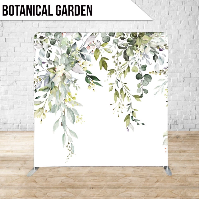 Botanical-themed backdrop with green leaves and flowers on a white background, set against a brick wall and wooden floor.