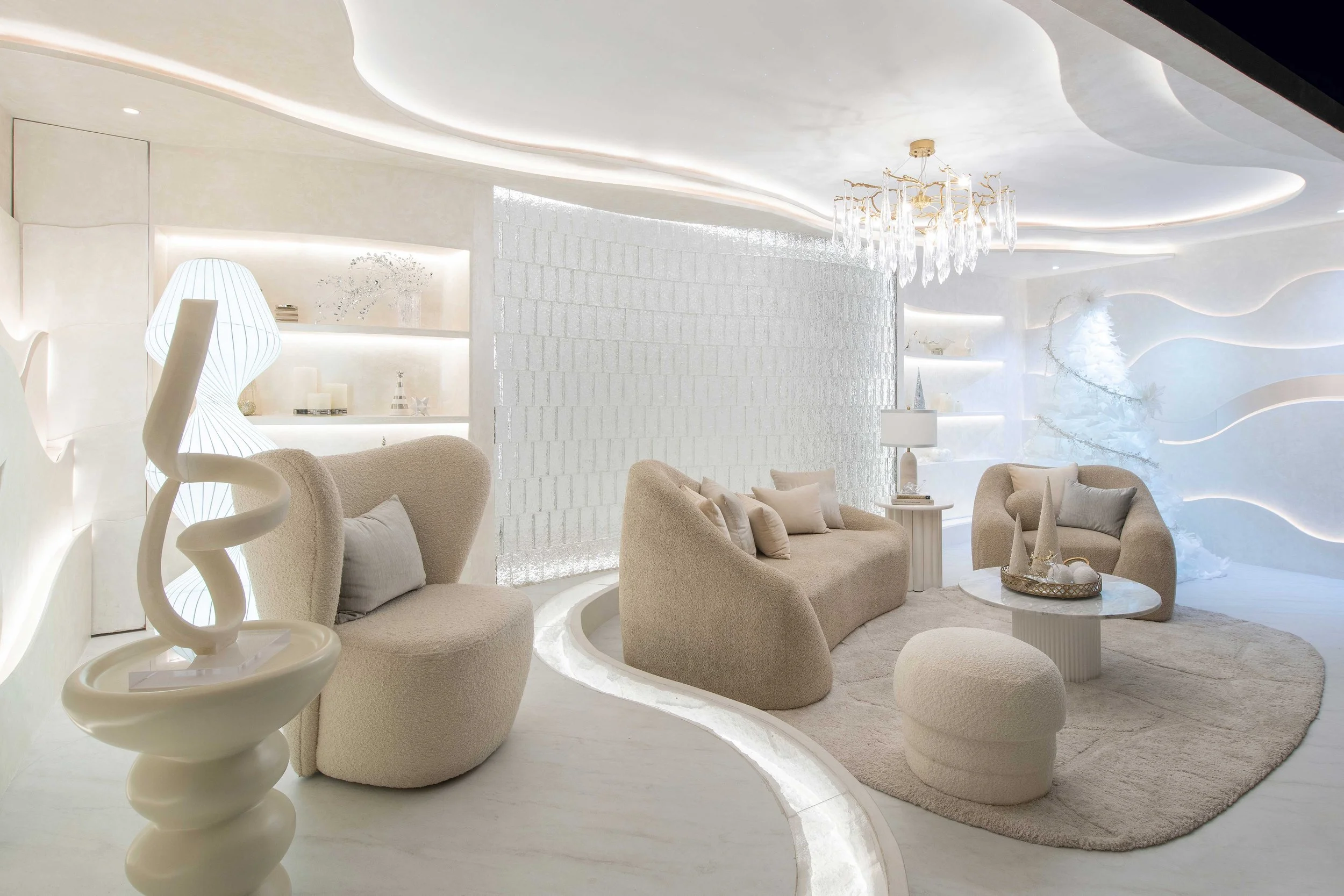 A luxurious, modern living room with soft, neutral-colored furniture, a chandelier, and stylish decor in an all-white, minimalist style.