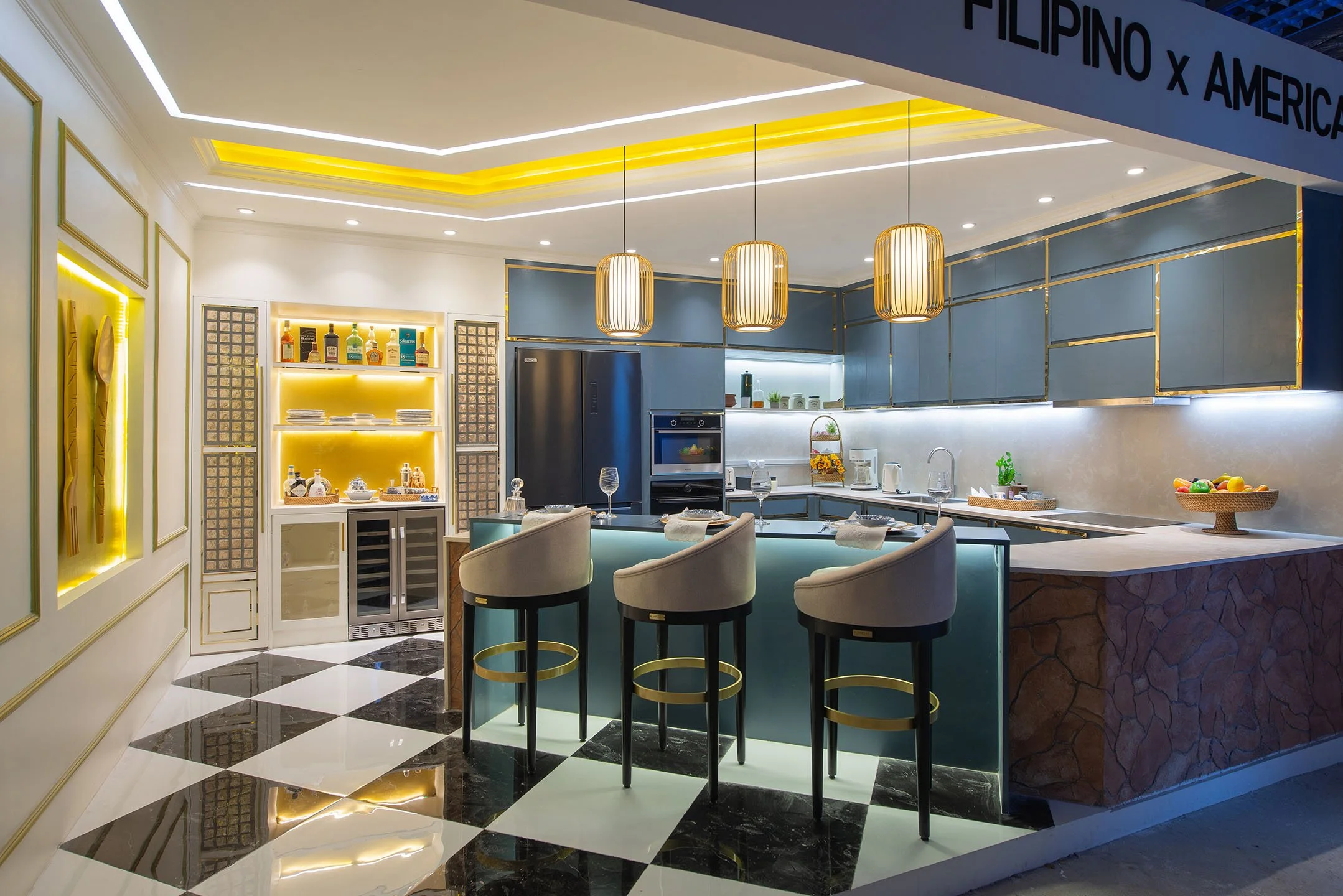 Modern kitchen with blue cabinets, gold accents, black and white checkered floor, and hanging pendant lights.