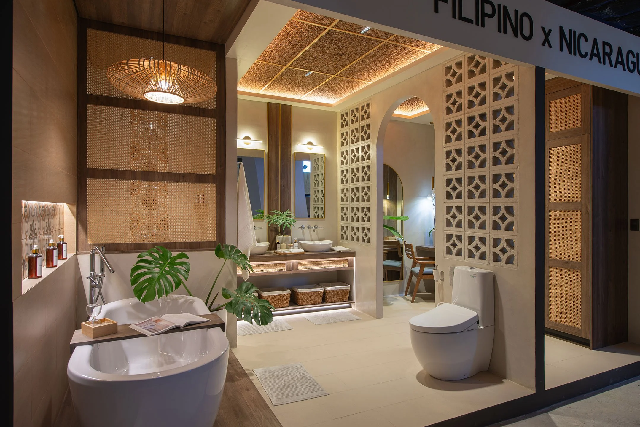 Interior view of a bathroom with modern design, featuring a white bathtub, two vessel sinks with mirrors, decorative screens, plants, and warm lighting.