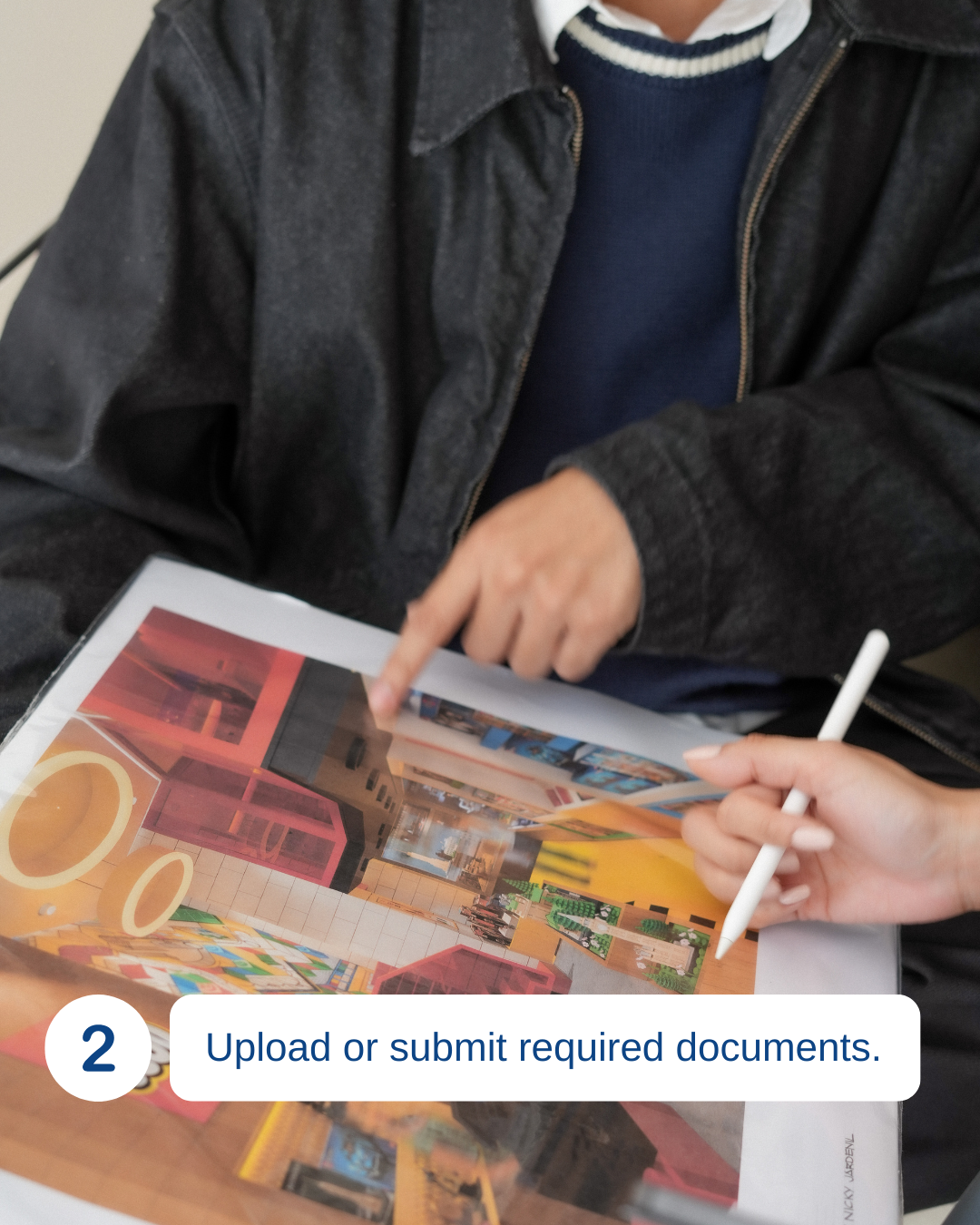 Person pointing at a colorful collage or magazine page, holding a white stylus, with another person holding the page. Text overlay says '2 Upload or submit required documents.'