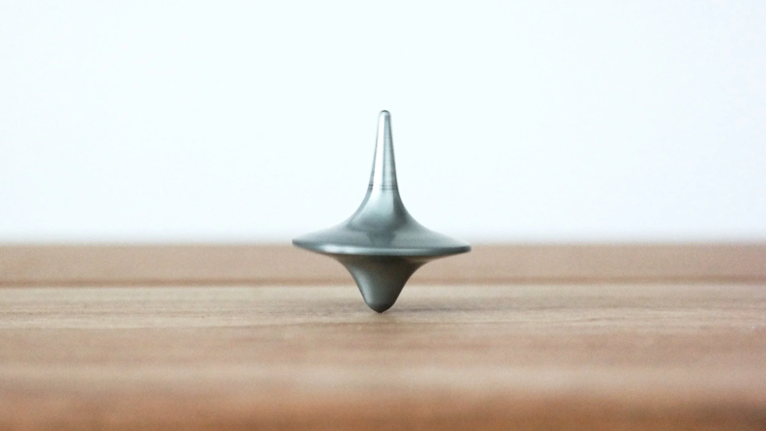 Spinning top representing the balances and business of life making us field tired but wired.