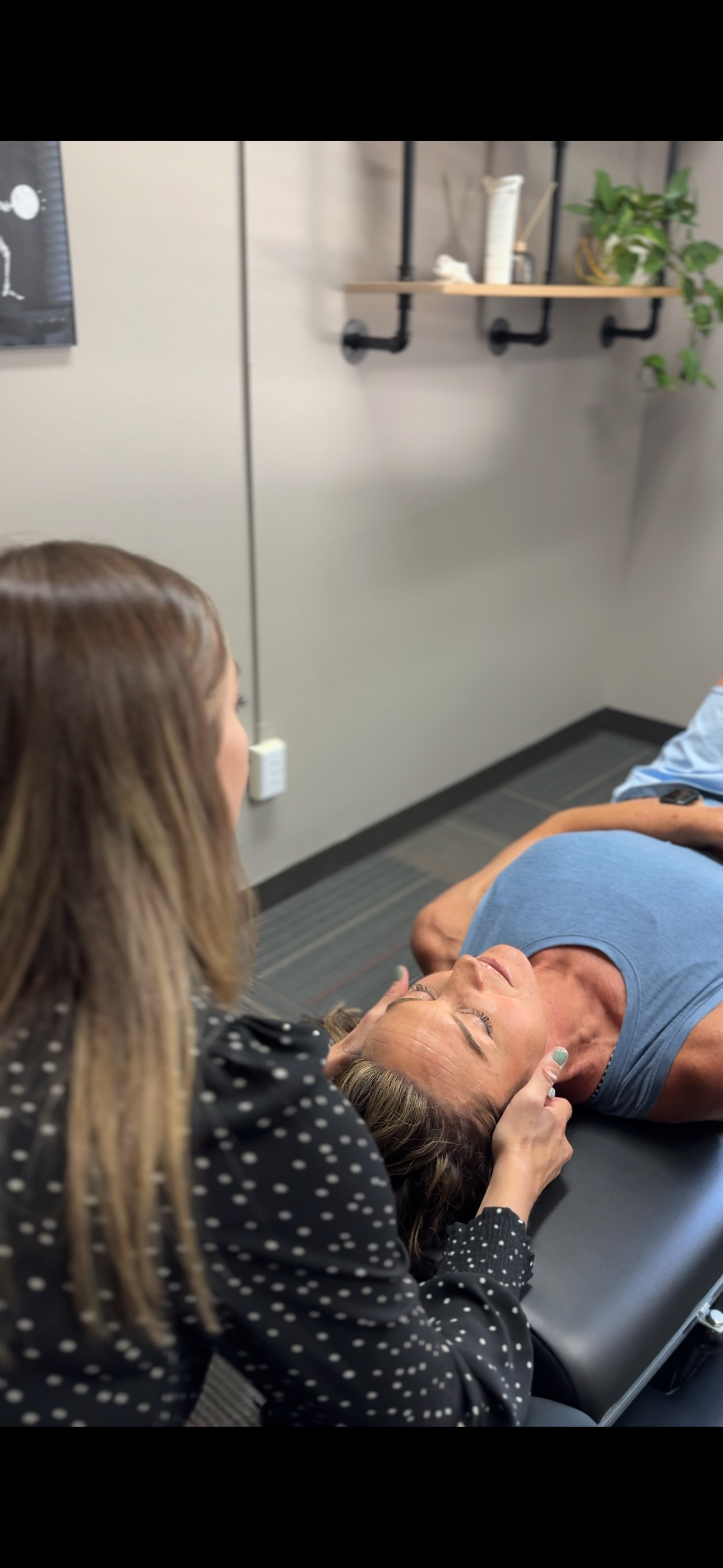 Doctor performing chiropractic adjustment on female with neck pain