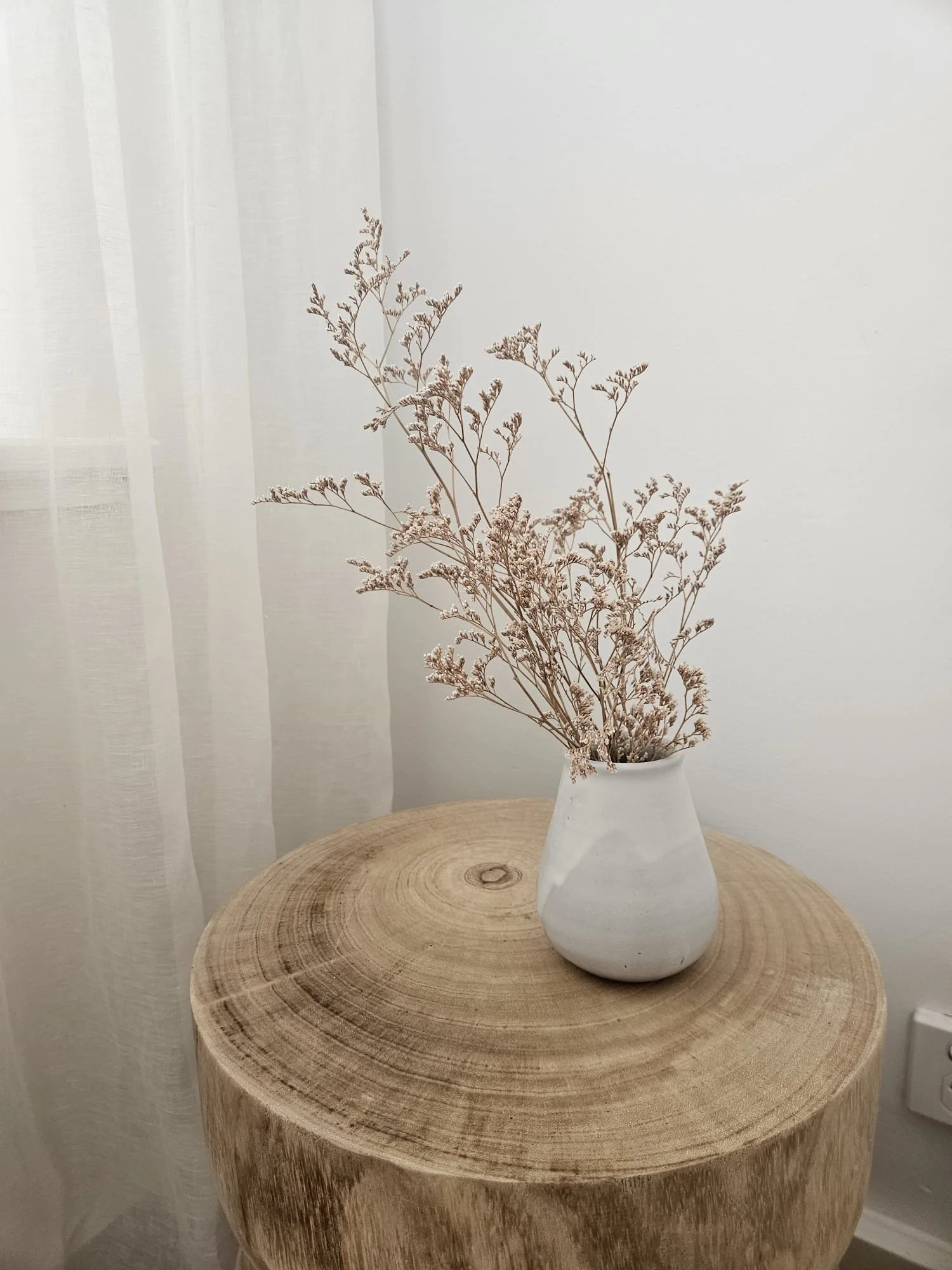 Ceramic vase with dried flowers on a timber stump side table, Glenelg Retreat, Young & Co Interiors