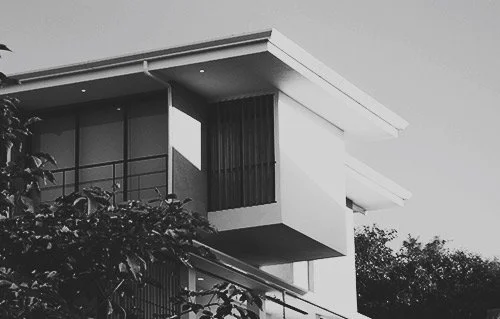 A modern architectural home exterior in monochrome.