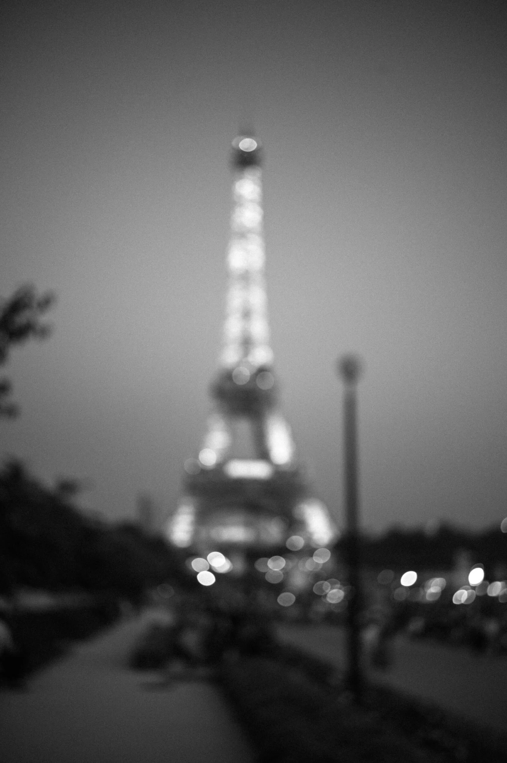Out-of-focus Eiffel Tower at dusk in Paris, photographed in black and white with the Leica M11 Monochrom and Mandler 35mm f/2 lens.