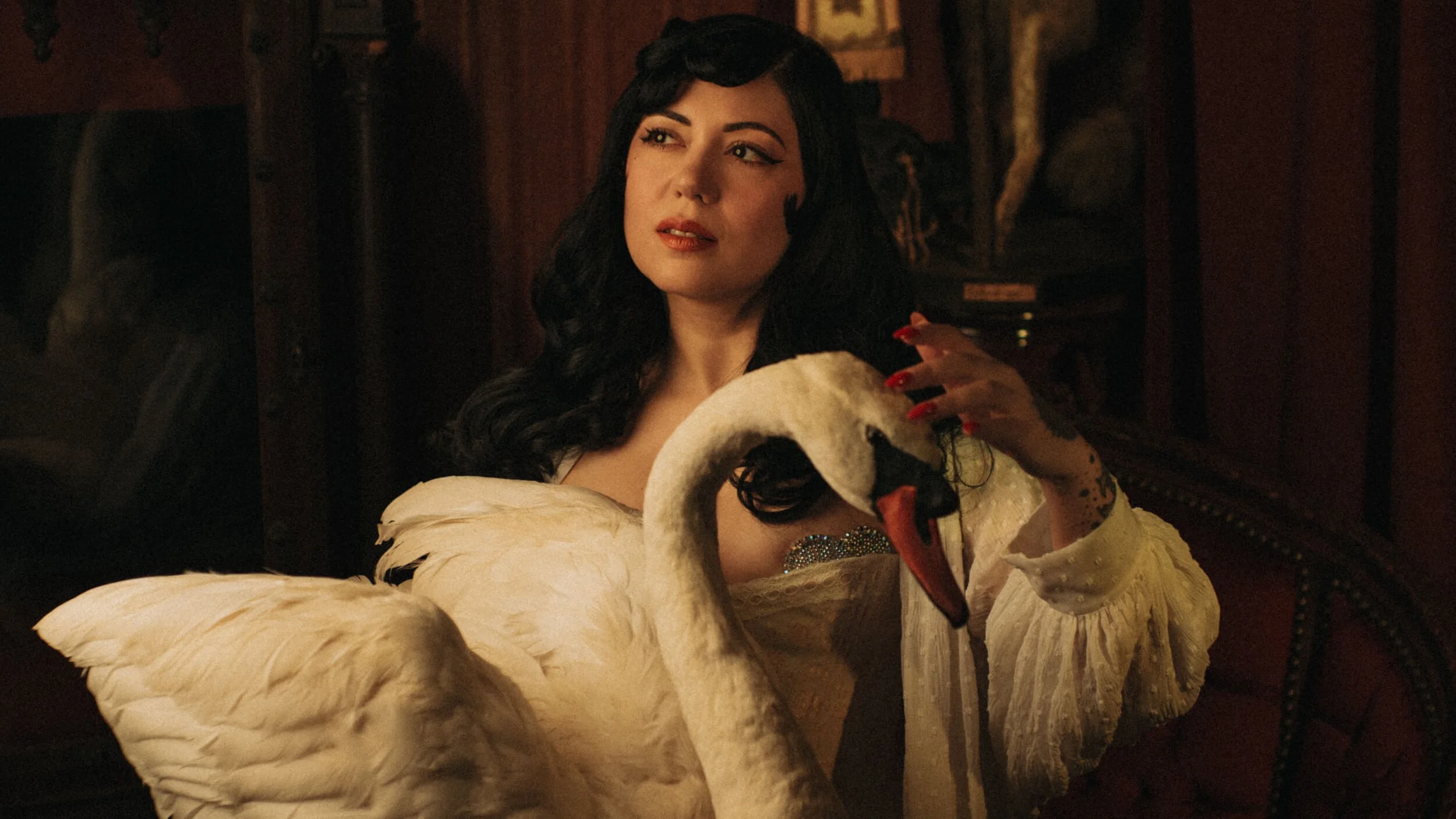 Cinematic portrait of Bettie with a white swan prop, photographed with the Mandler 50mm f/1.4 E46 Pre-A on the Leica M11-D.