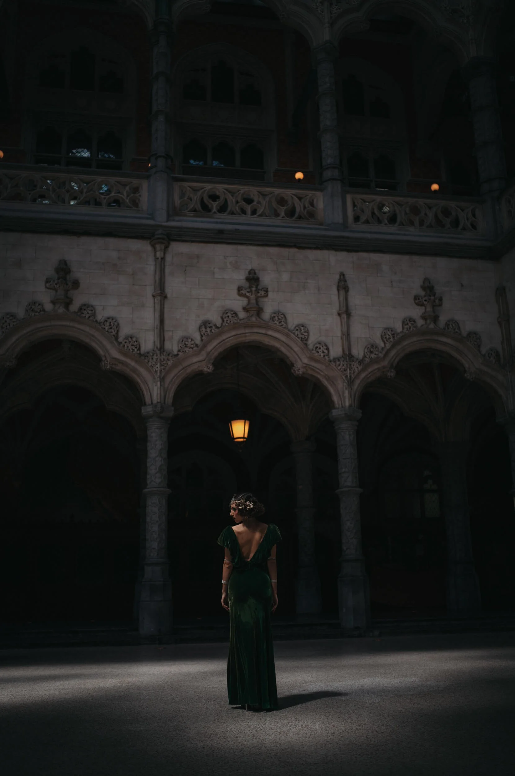 Chanelle standing beneath dramatic light inside the historic Handelsbeurs in Antwerp photographed with the Thypoch Ksana 35mm f/2